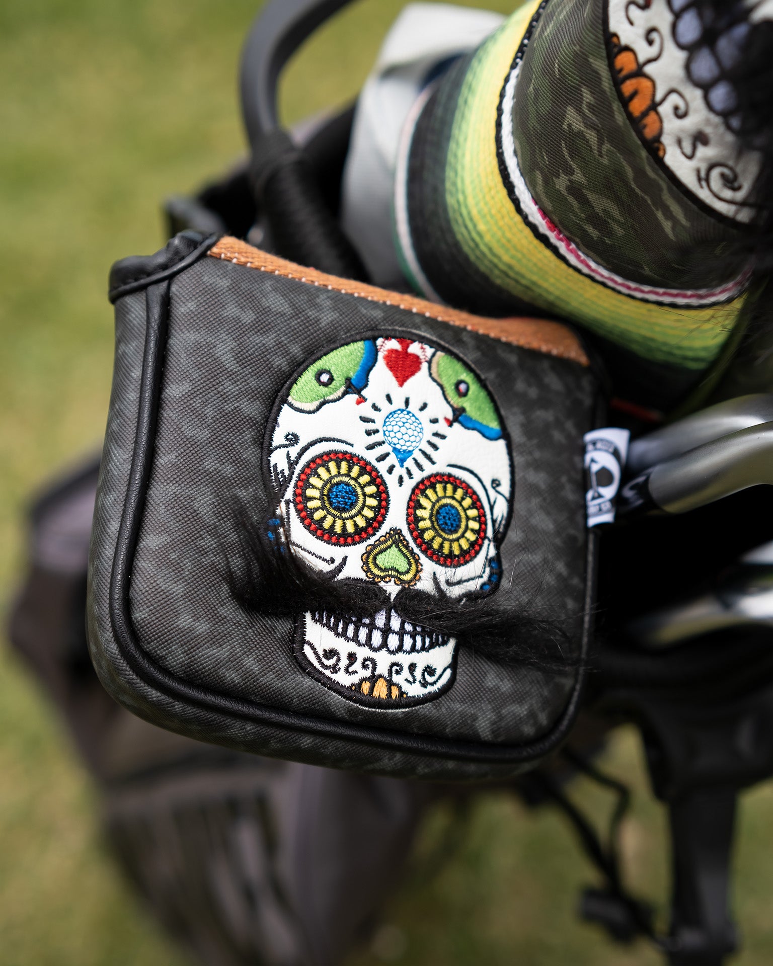 Mustache Sugar Skull mallet putter cover in gray camo pattern, featuring intricate detailing and a stylish design for golfers.