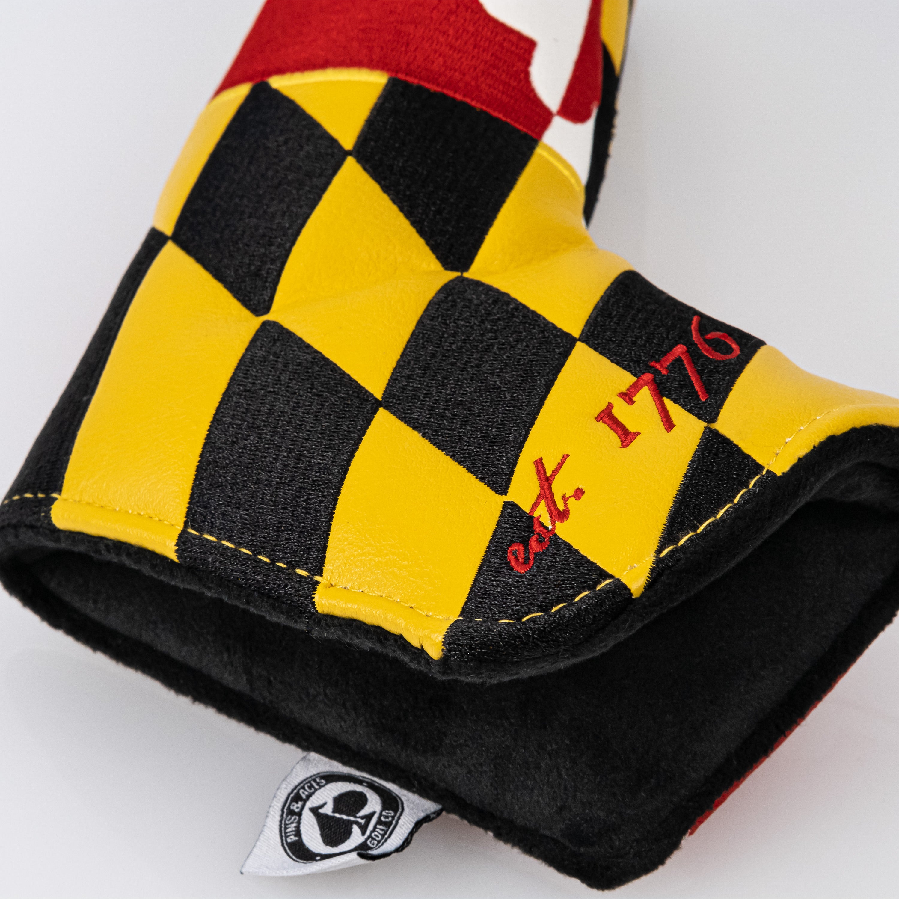 Maryland blade putter cover featuring a vibrant Maryland flag design, showcasing an open view with soft interior cushioning.