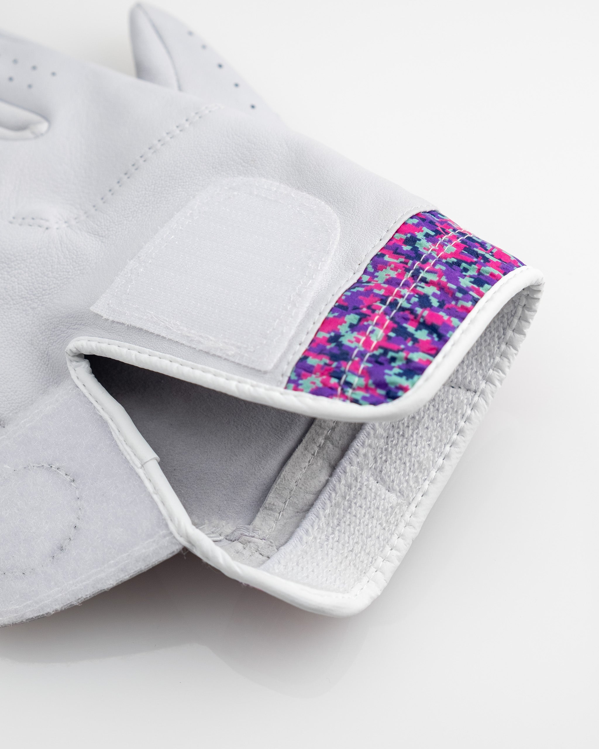 Premium Tour Glove in vivid camo design, showcasing its moisture-wicking cuff and stylish pattern.