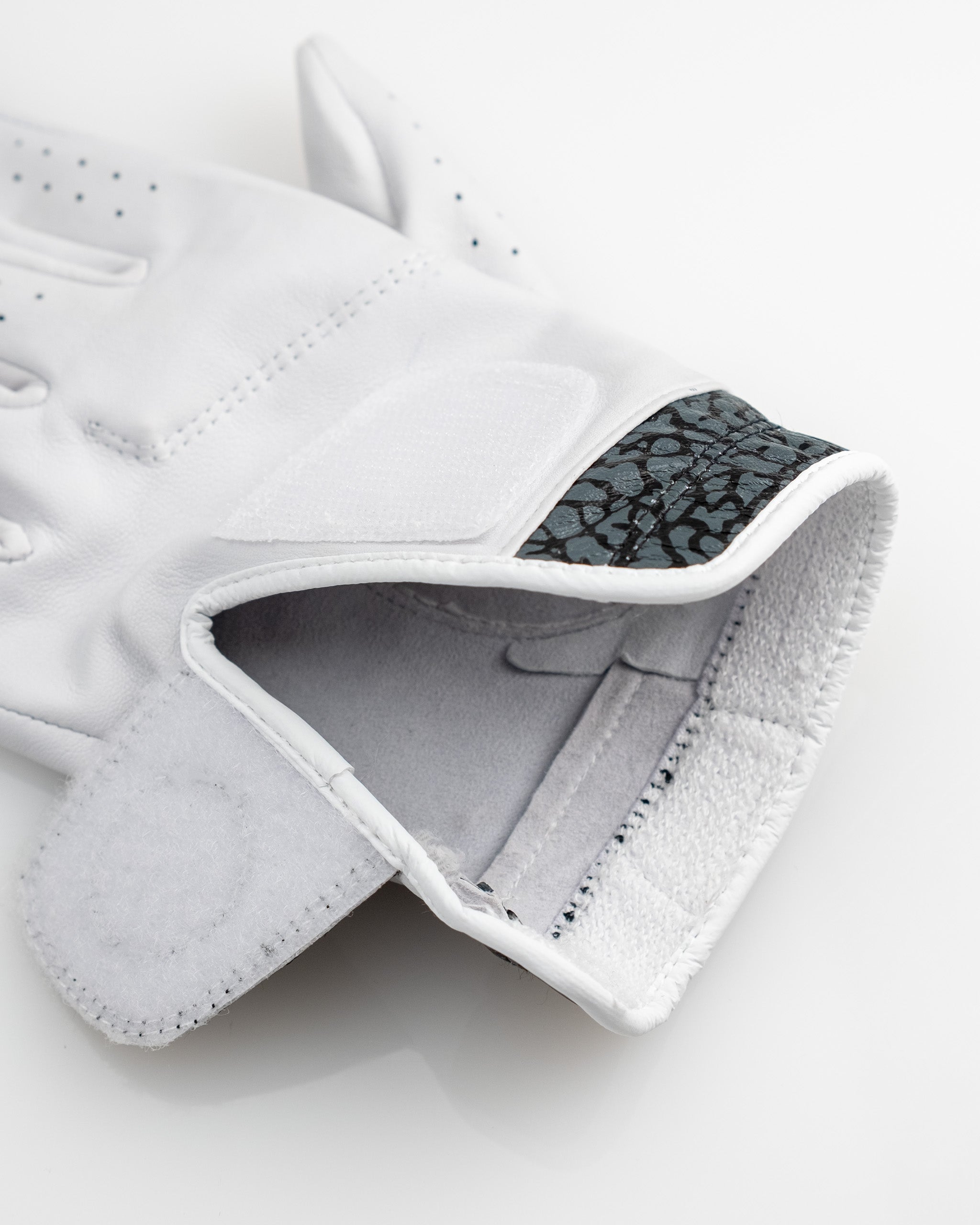 Premium Tour Glove featuring an elephant print design, ideal for golfing, with moisture-wicking cuff and high-quality materials.