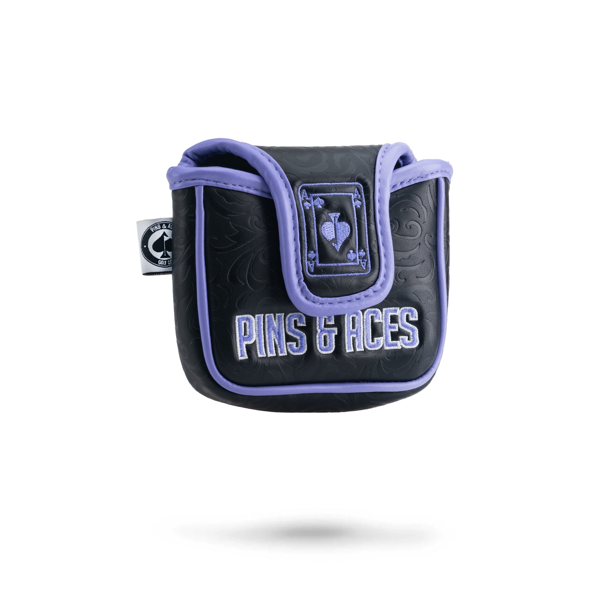 Alt text: "Ace of Spades-themed mallet putter cover by Pins & Aces featuring a dark base with black, embossed patterns and a prominent purple Ace of Spades logo. The cover is outlined in purple trim with the 'P