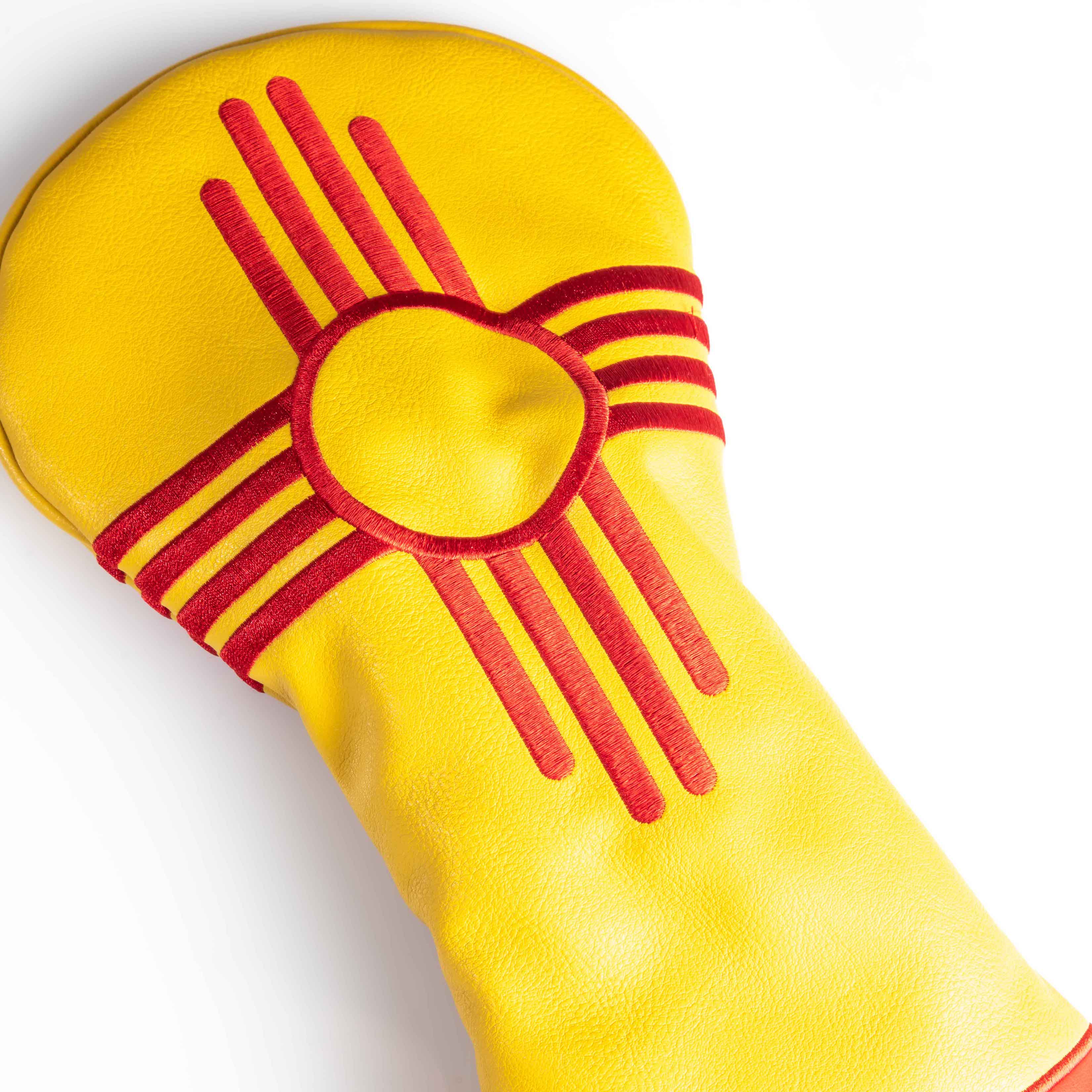 New Mexico State Flag Driver Cover featuring vibrant red sun symbol and yellow background, designed for golf clubs.