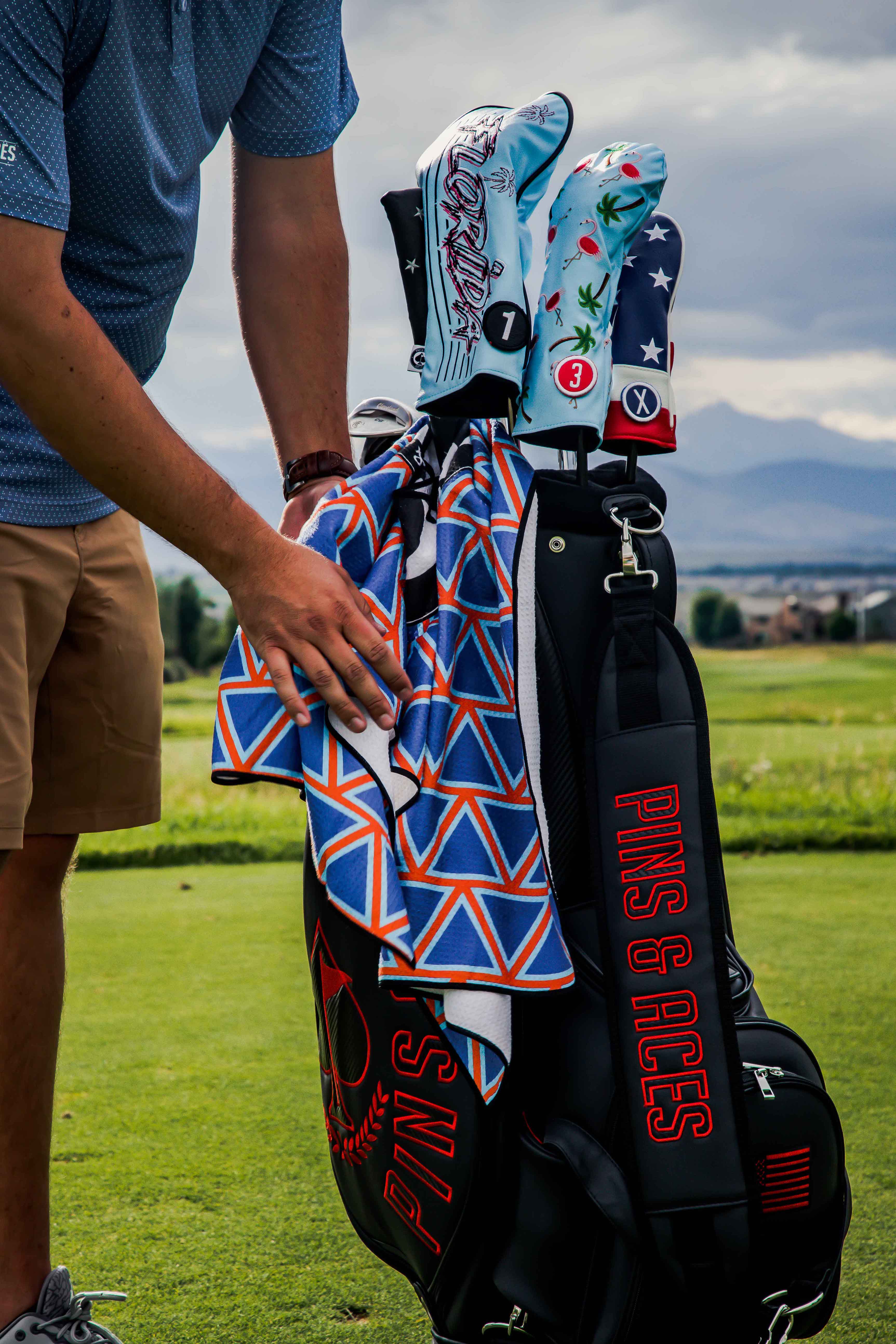 Colorful fairway cover featuring dancing flamingos, styled with vibrant patterns, enhancing a golfer's bag on the course.