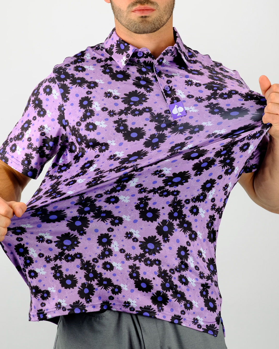 Bold purple golf shirt featuring a dark daisy pattern, designed for golfers who want to stand out on the course.