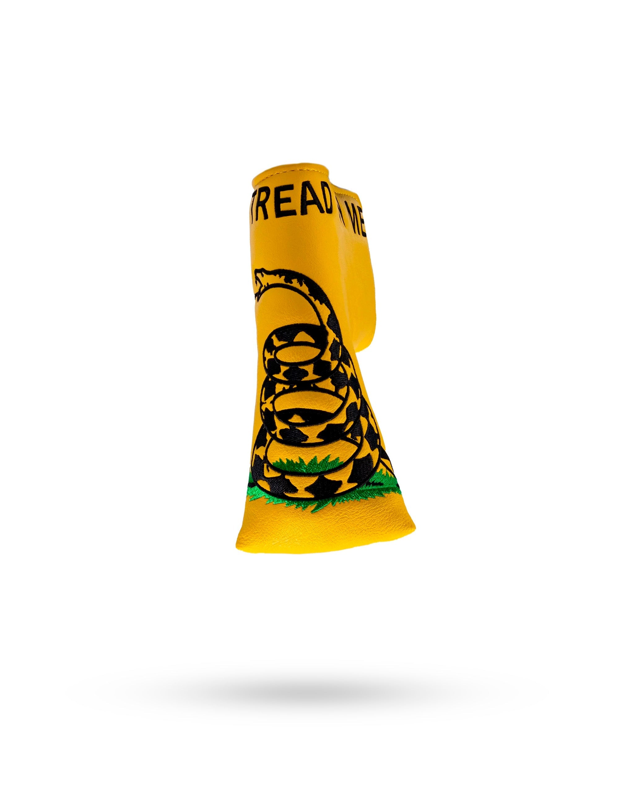 Bold yellow blade putter cover featuring the "Don't Tread on Me" design with a coiled snake and grass details.