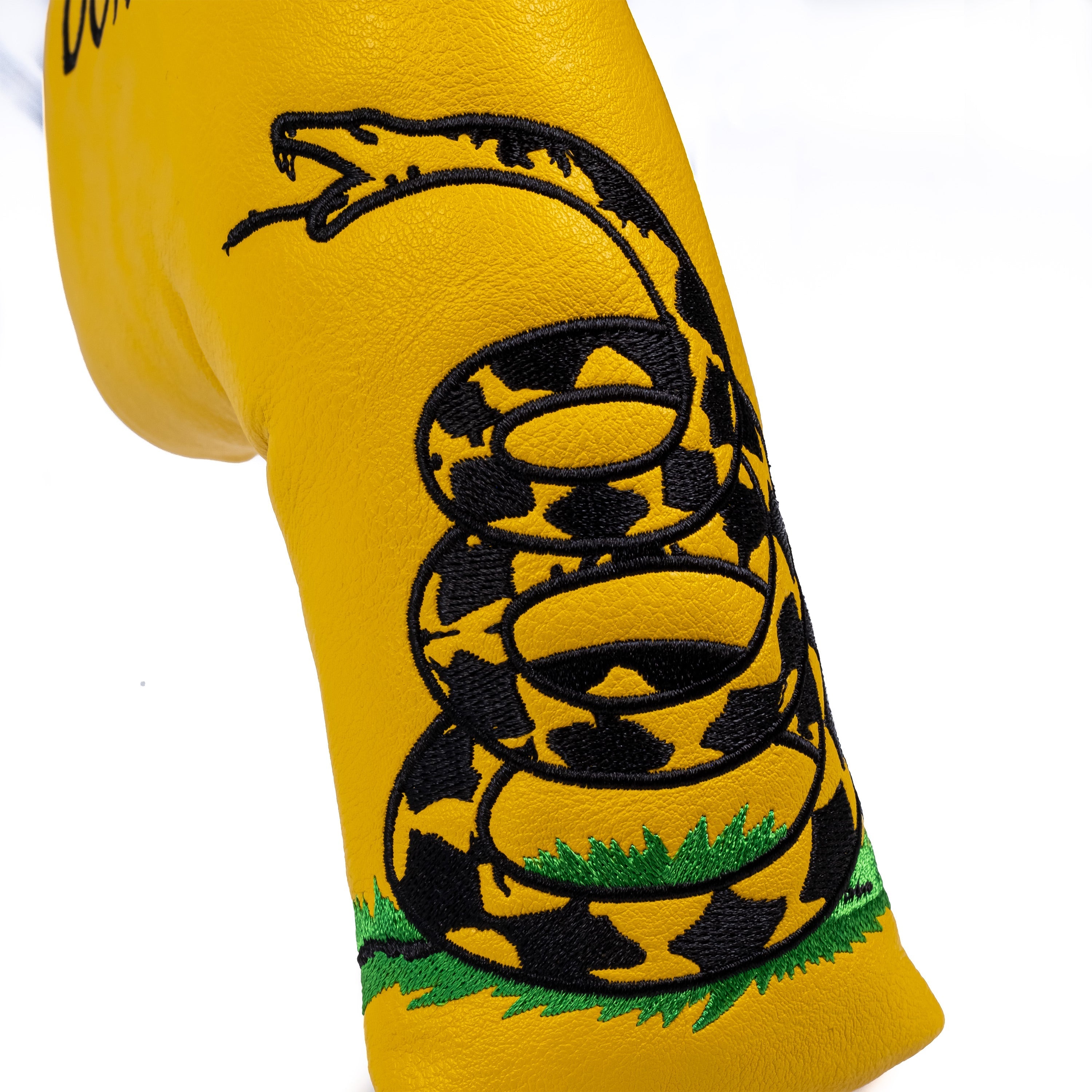 Bold yellow blade putter cover featuring a coiled snake design, perfect for golfers who want to make a statement on the course.