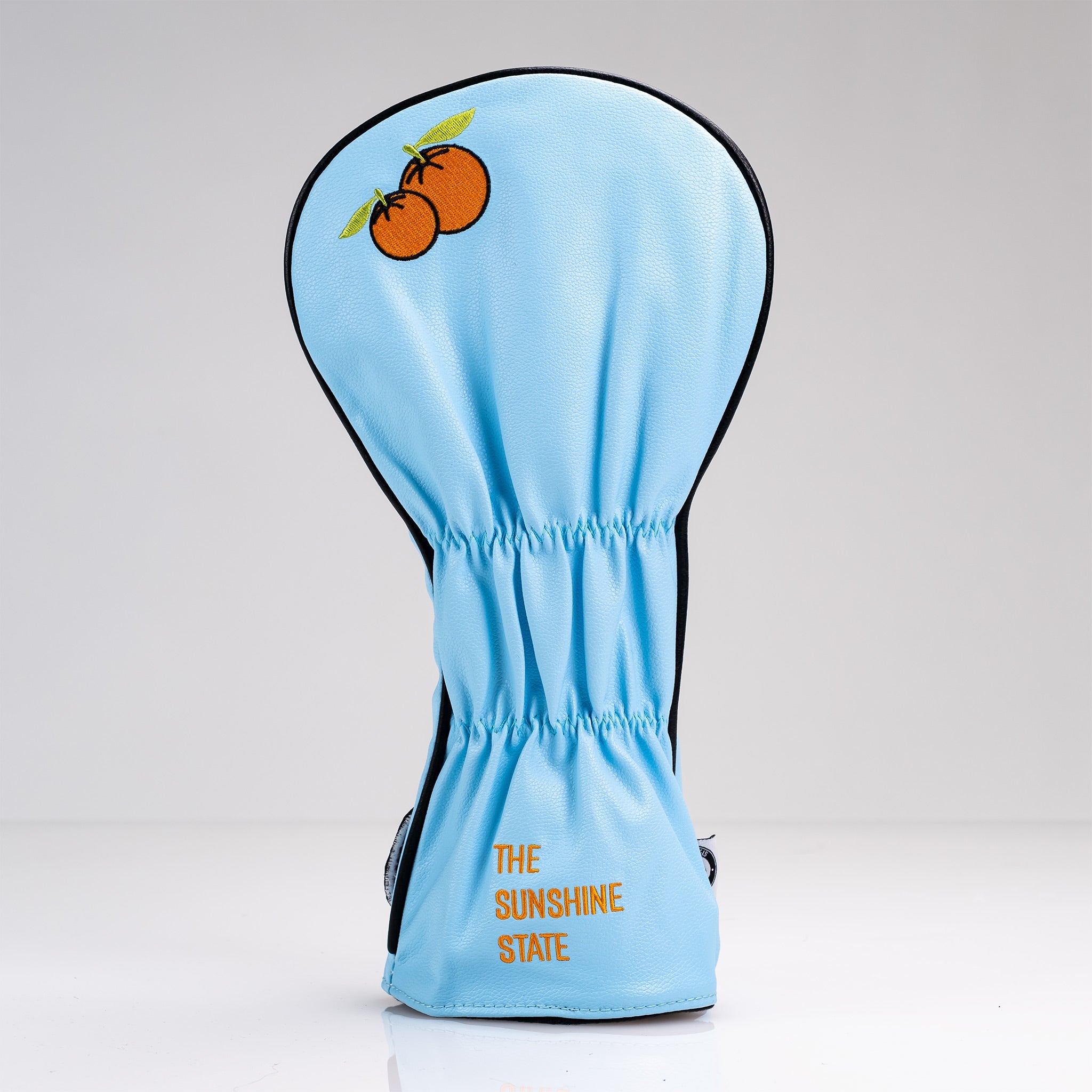 Light blue fairway cover featuring orange fruit graphics and "The Sunshine State" text, perfect for stylish golfers.
