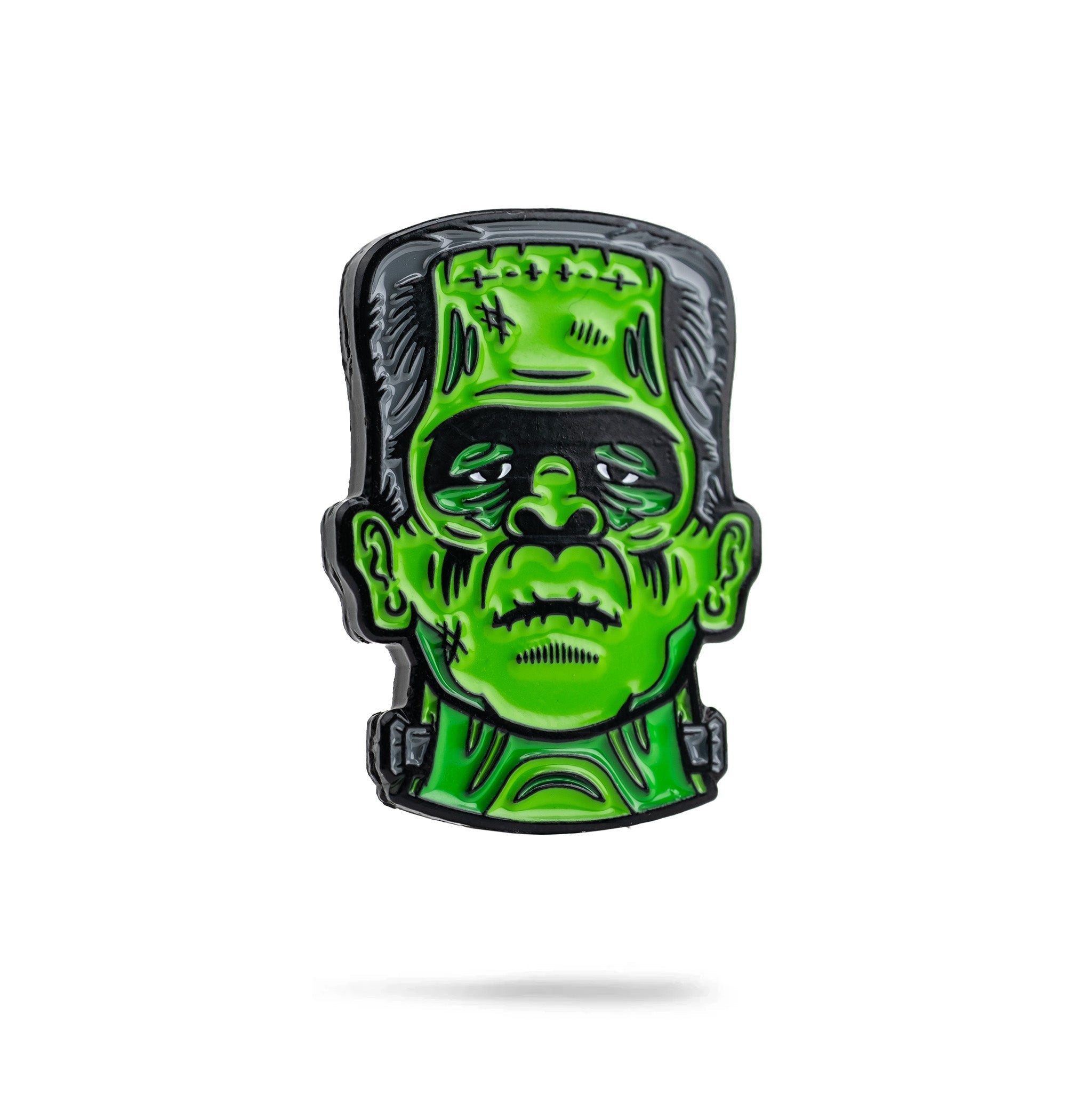 Frankenstein-themed ball marker featuring a vibrant green face with detailed features, perfect for unique golf accessories.
