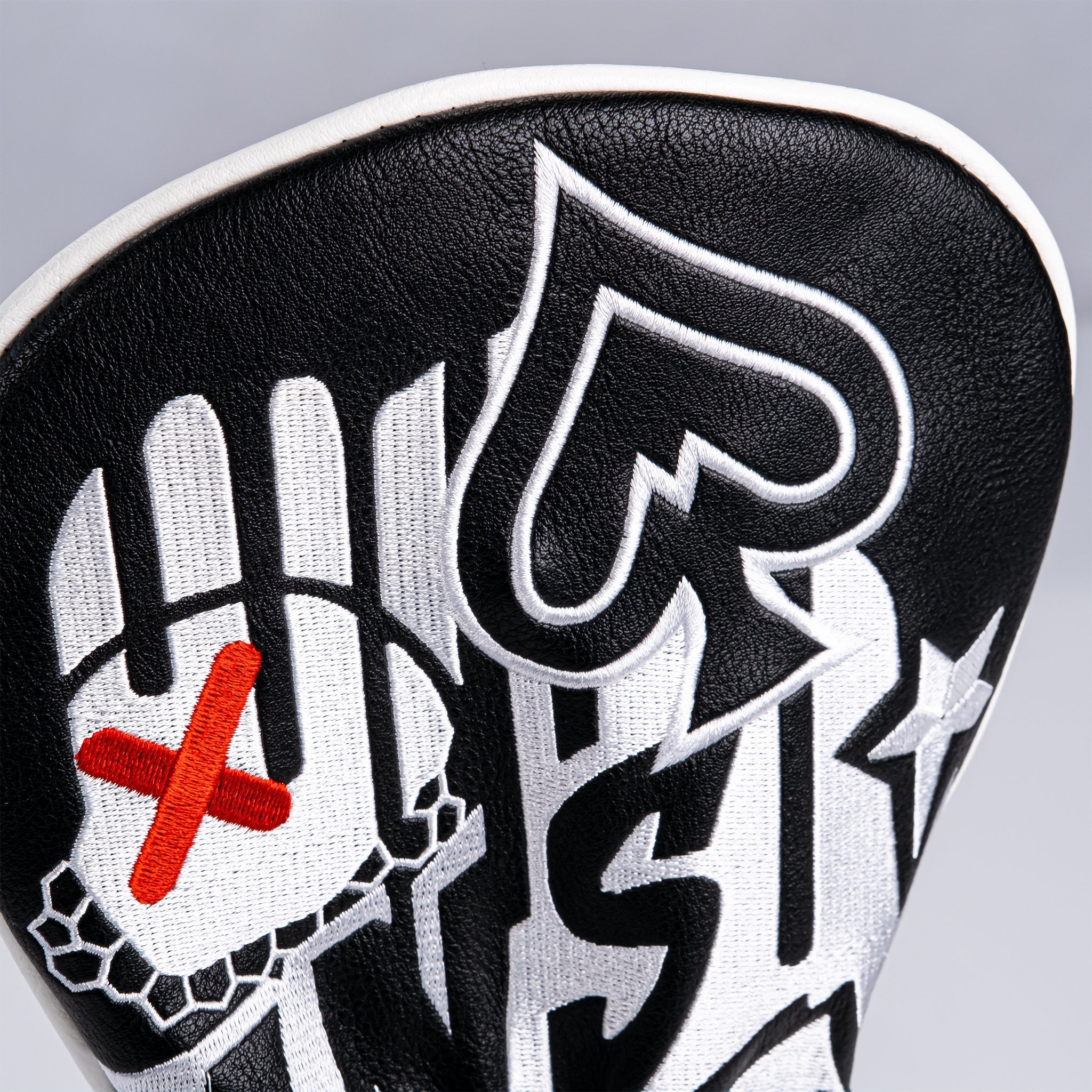Bold black and white fairway cover featuring graffiti-style designs and vibrant accents for a standout look on the golf course.