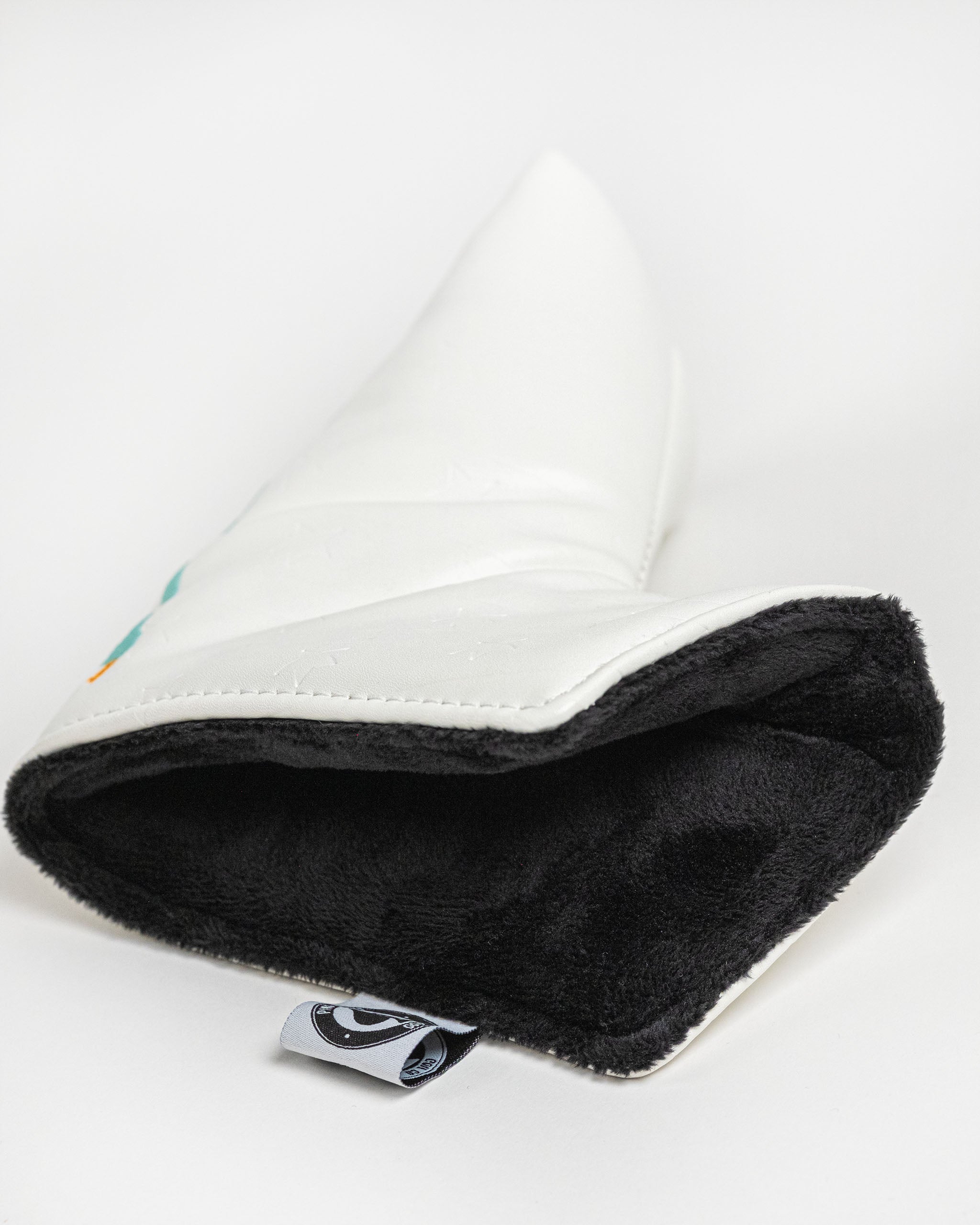 White blade putter cover featuring a soft black interior, designed for golfers seeking stylish protection for their clubs.