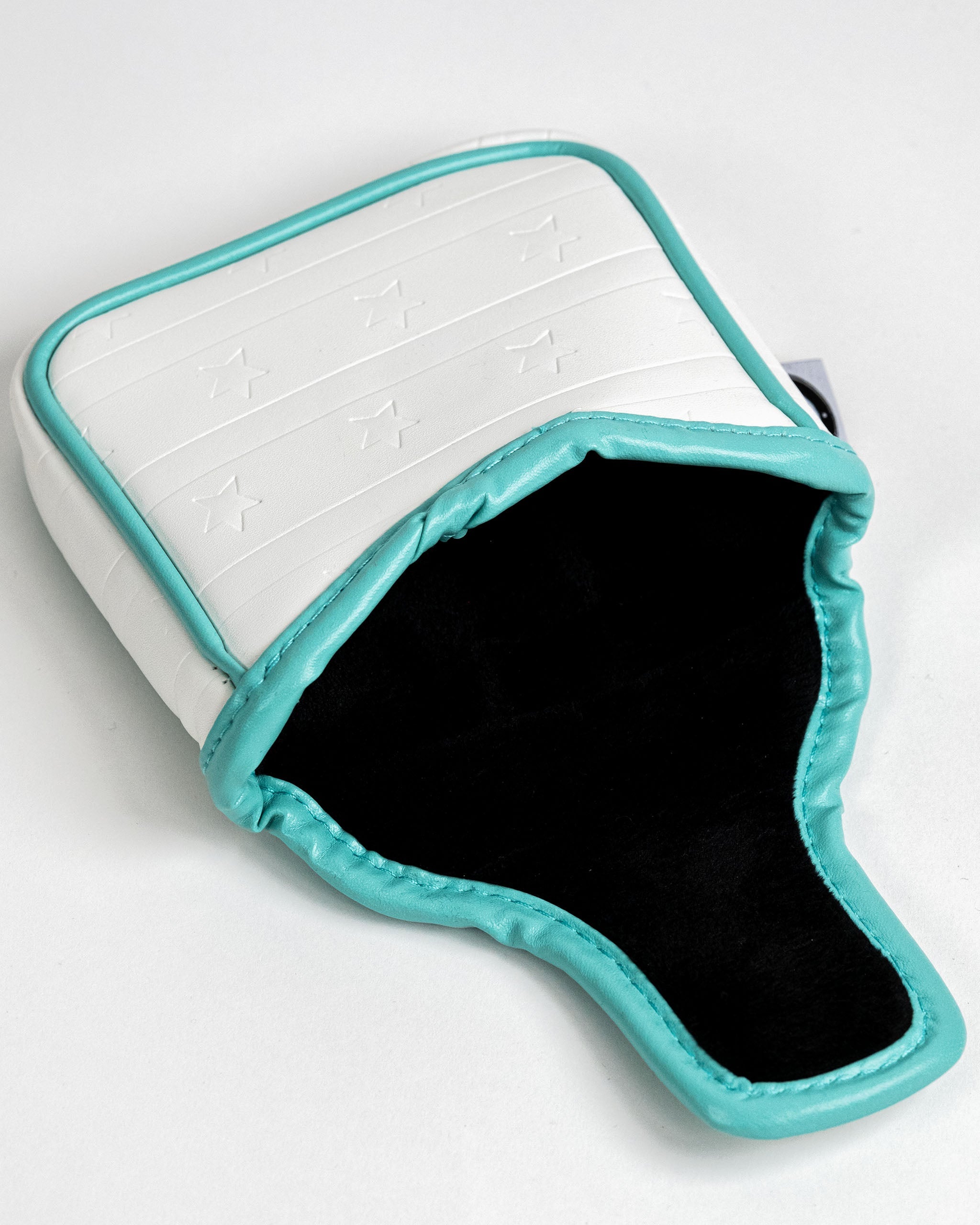 White mallet putter cover with a teal trim and embossed star pattern, designed for stylish golf protection.