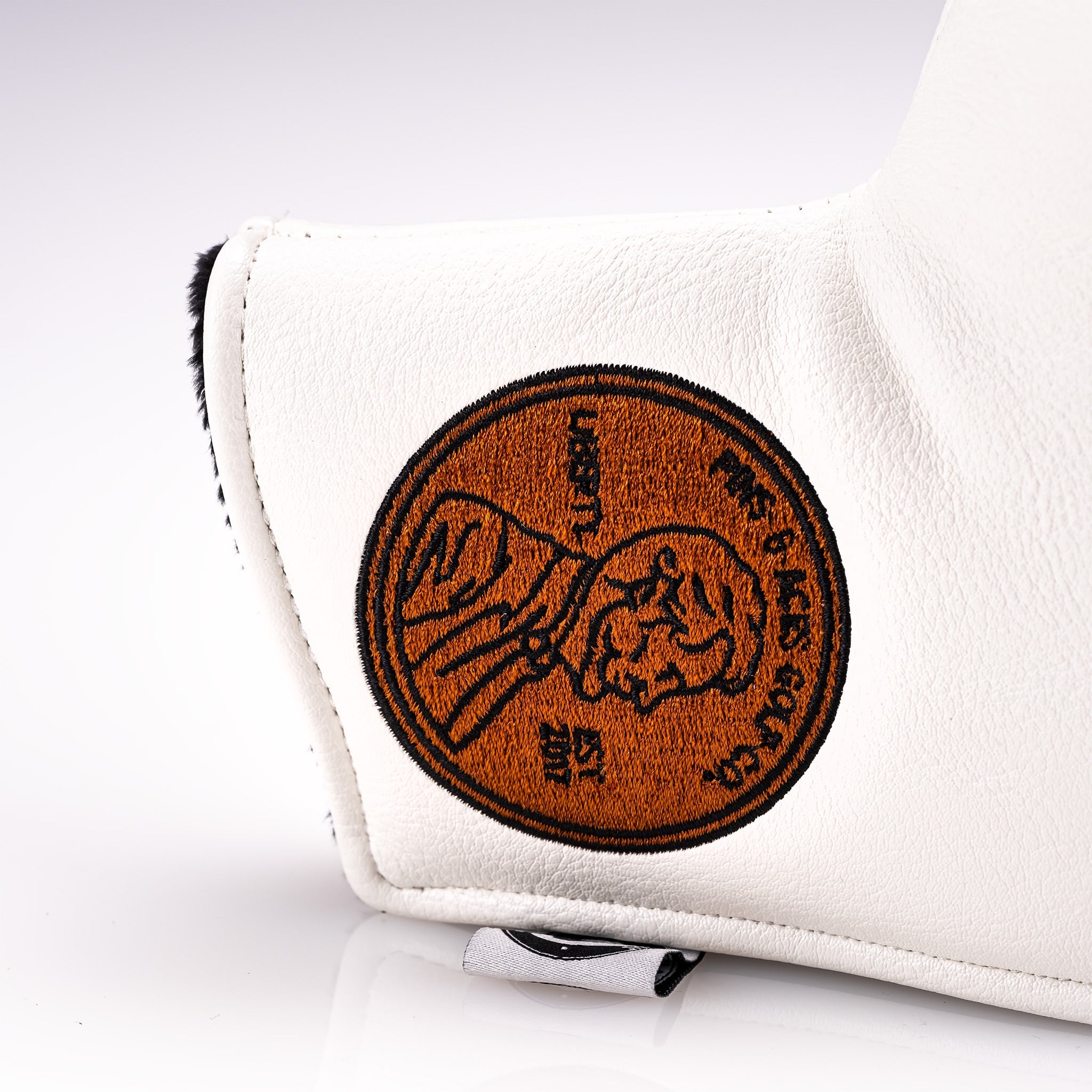 White blade putter cover featuring a detailed Lincoln penny design, perfect for golfers seeking a unique accessory.