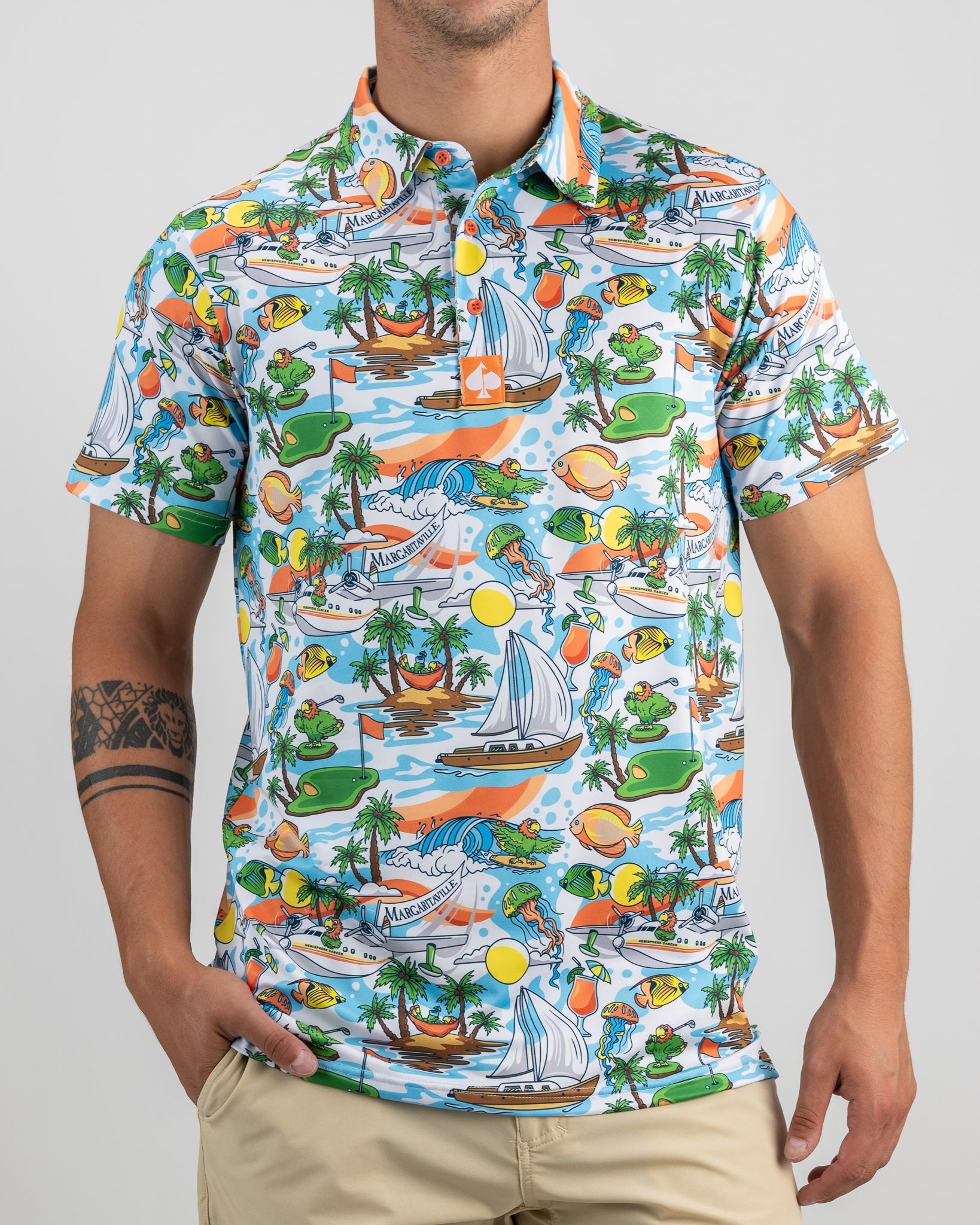 Colorful Margaritaville golf shirt featuring a tropical paradise print with boats, palm trees, and vibrant sun motifs.