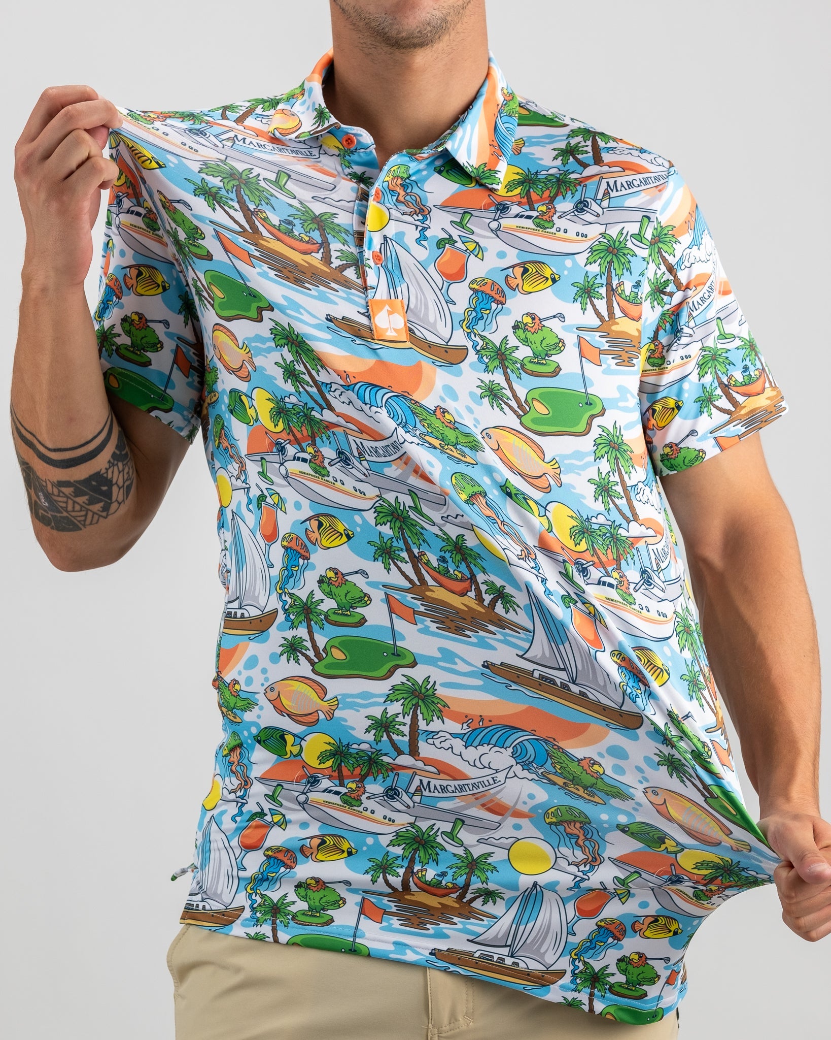 Vibrant Margaritaville golf polo featuring a tropical design with boats, palm trees, and playful sea creatures.