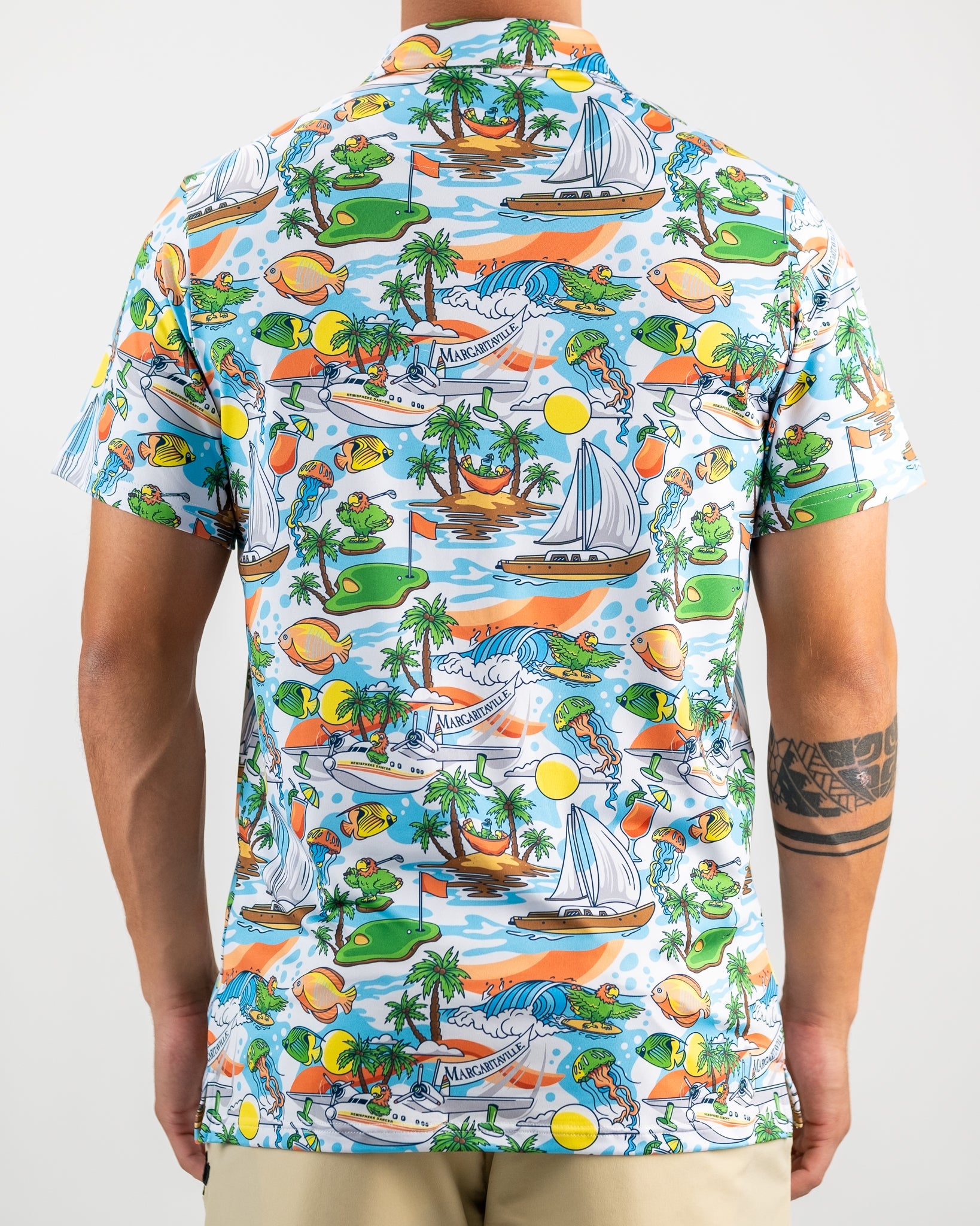 Colorful Margaritaville shirt featuring a tropical paradise design with boats, palm trees, and playful sea creatures.