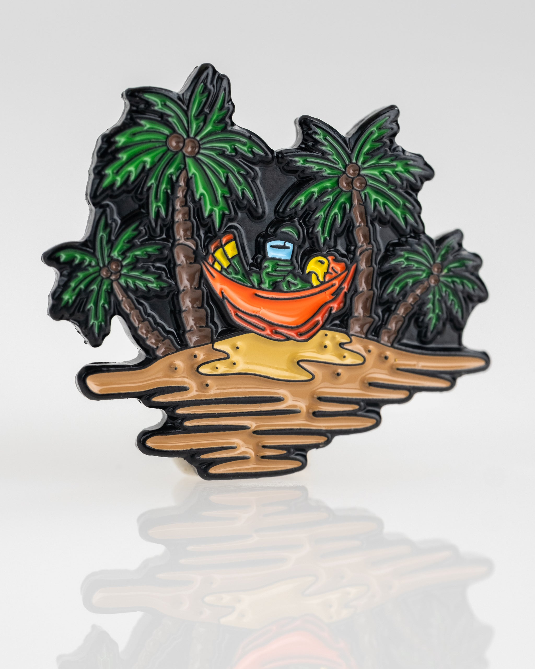Colorful Margaritaville Sleeping Parrot ball marker featuring a parrot in a hammock surrounded by palm trees on a sandy beach.