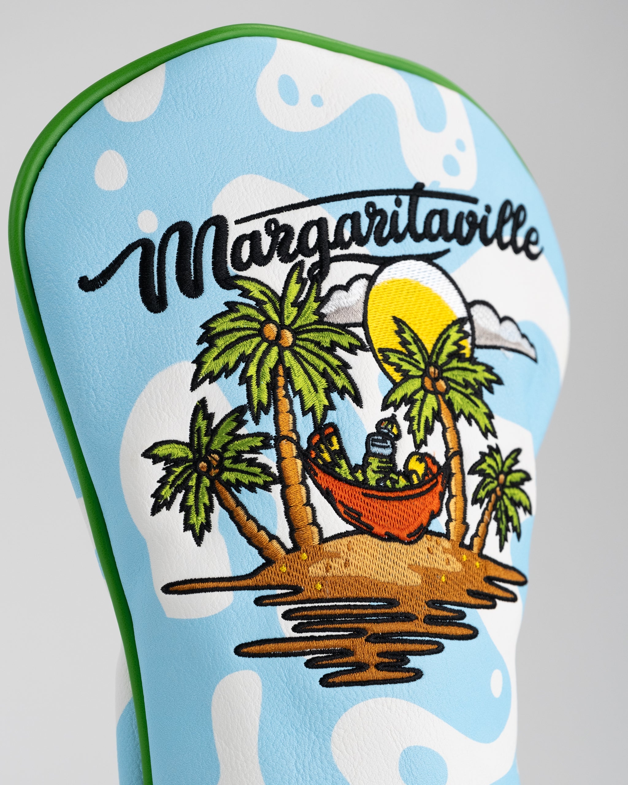 Colorful Margaritaville driver cover featuring a tropical island scene with palm trees and a hammock under the sun.