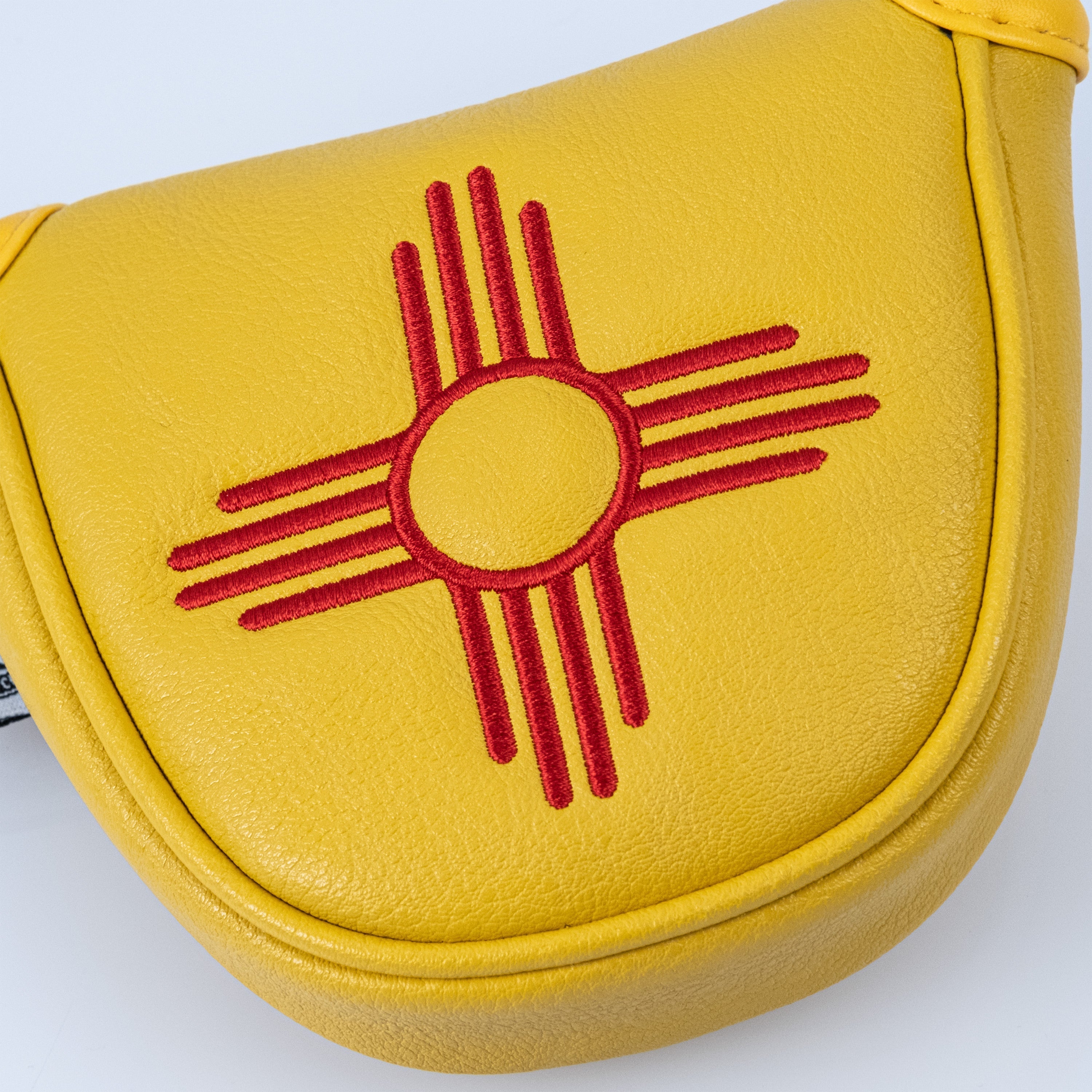 New Mexico State Flag mallet putter cover in yellow leather with red emblem, perfect for bold golf style.