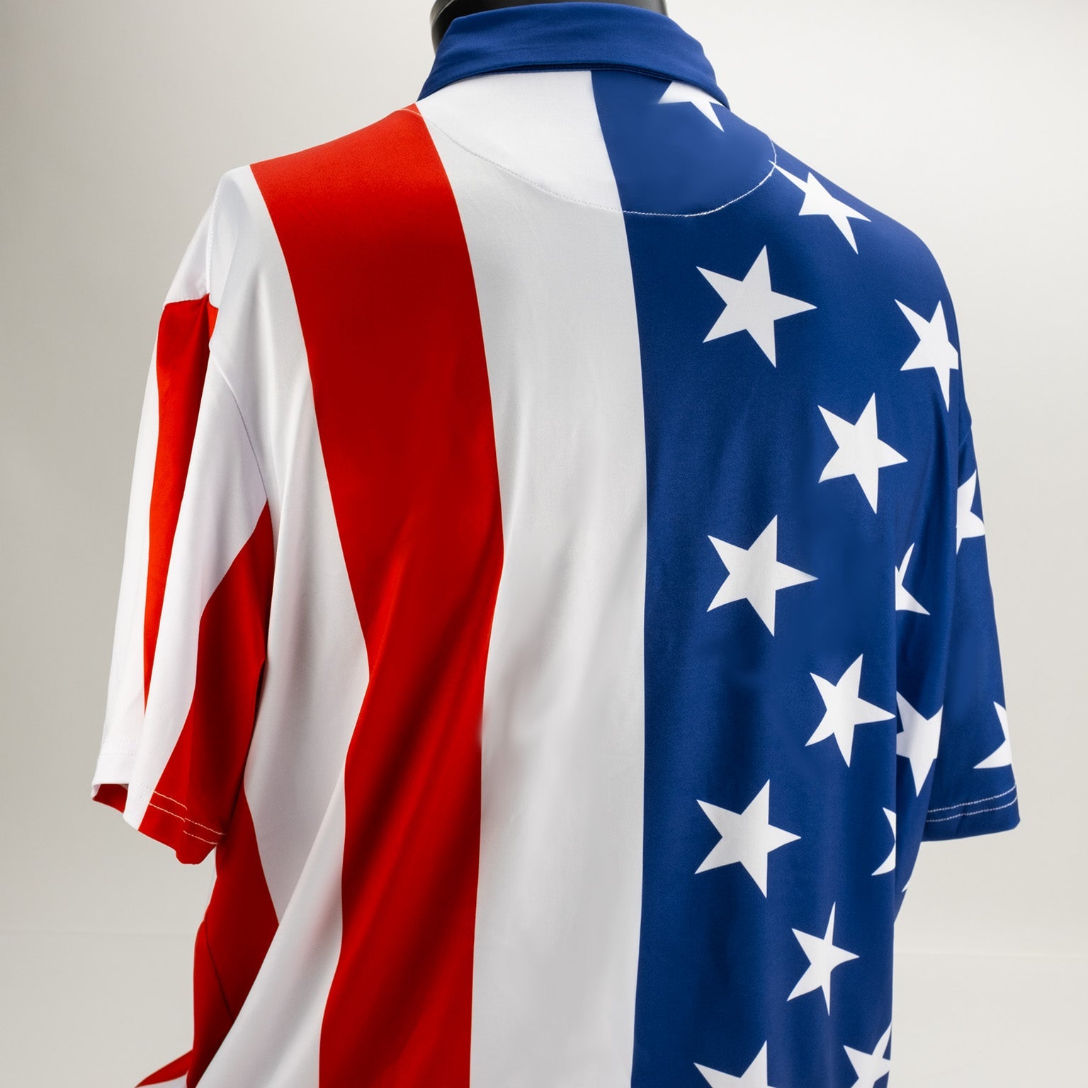 Bold golf polo featuring a patriotic design with red and white stripes and a blue section adorned with white stars.