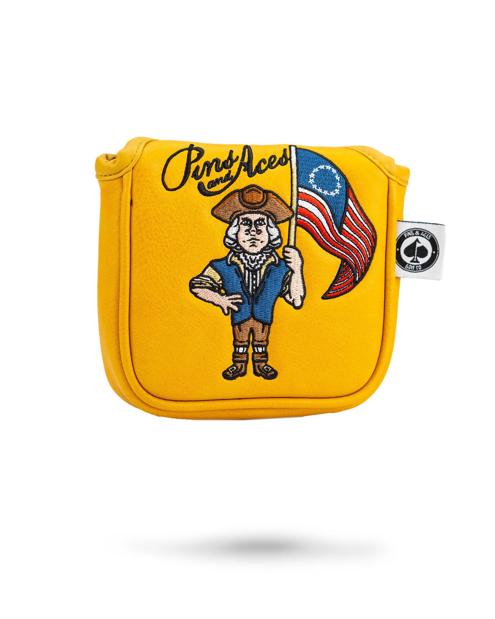Bold yellow mallet cover featuring a cartoon patriot holding an American flag, designed for golfers seeking unique accessories.
