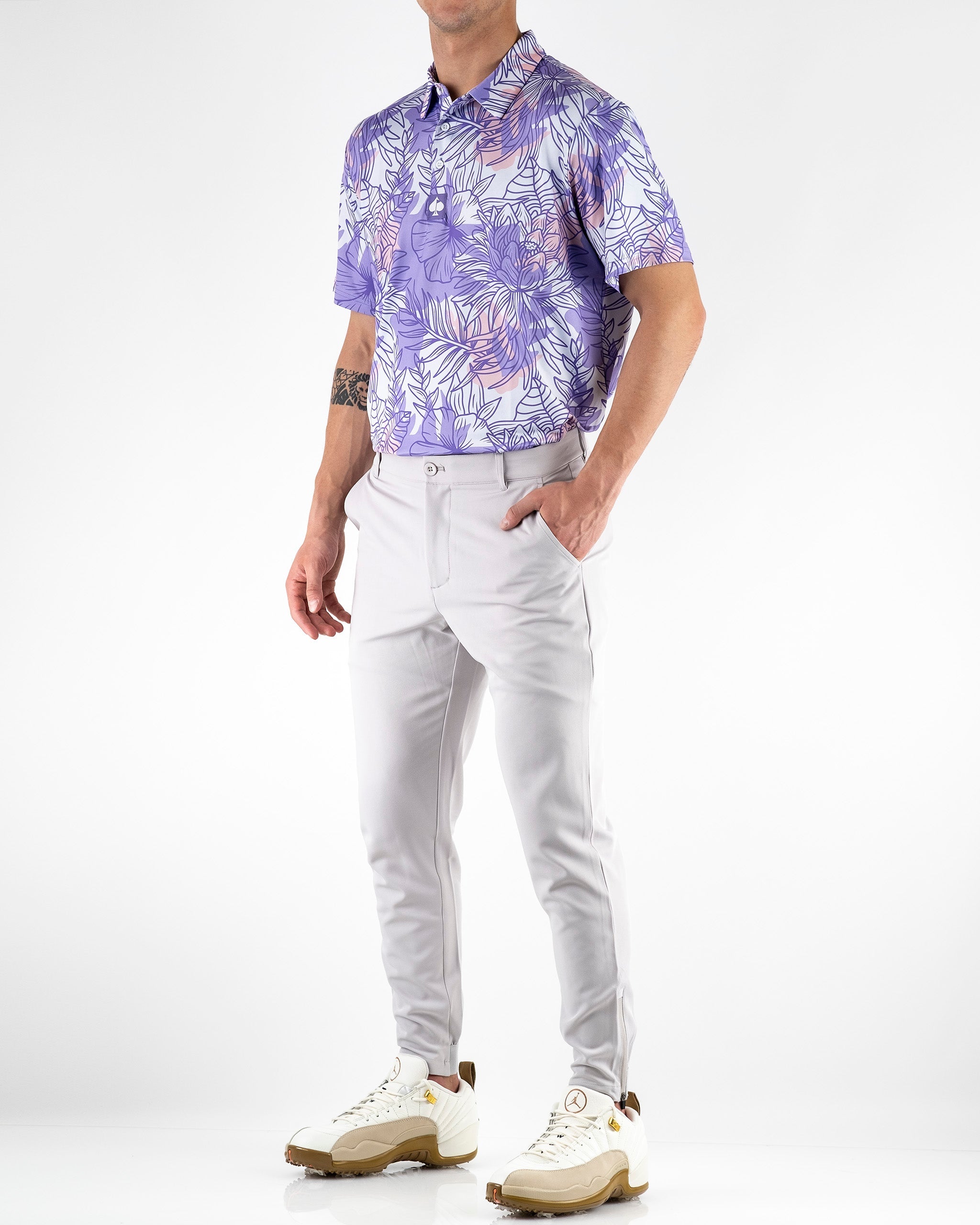 Men's performance jogger in stone color, paired with a floral polo shirt, designed for stylish comfort on the golf course.