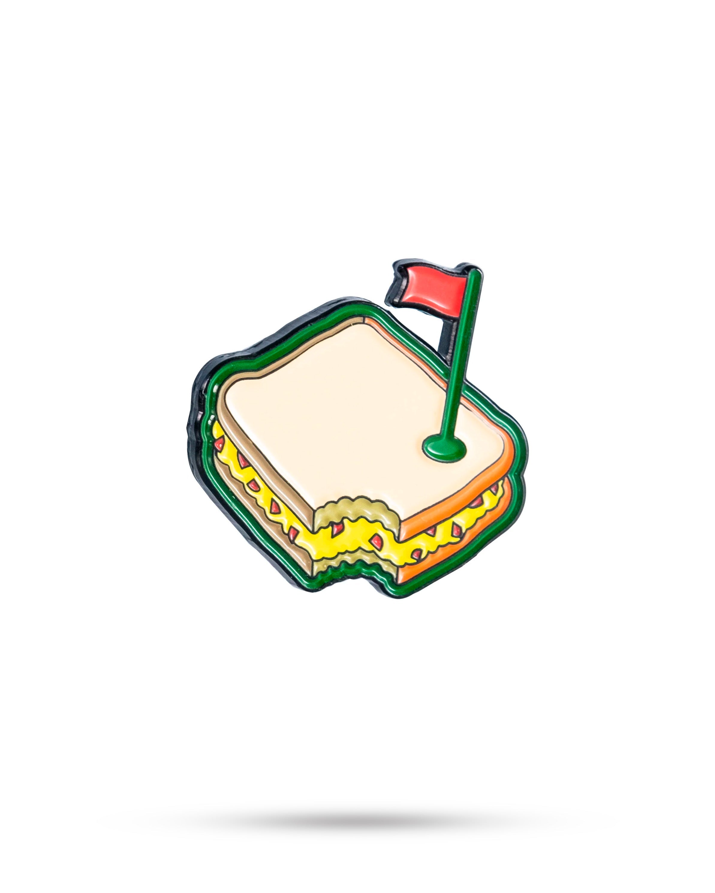 Colorful enamel golf-themed pin featuring a sandwich with mustard, lettuce, and a red flag on top. Perfect for bold golf a...