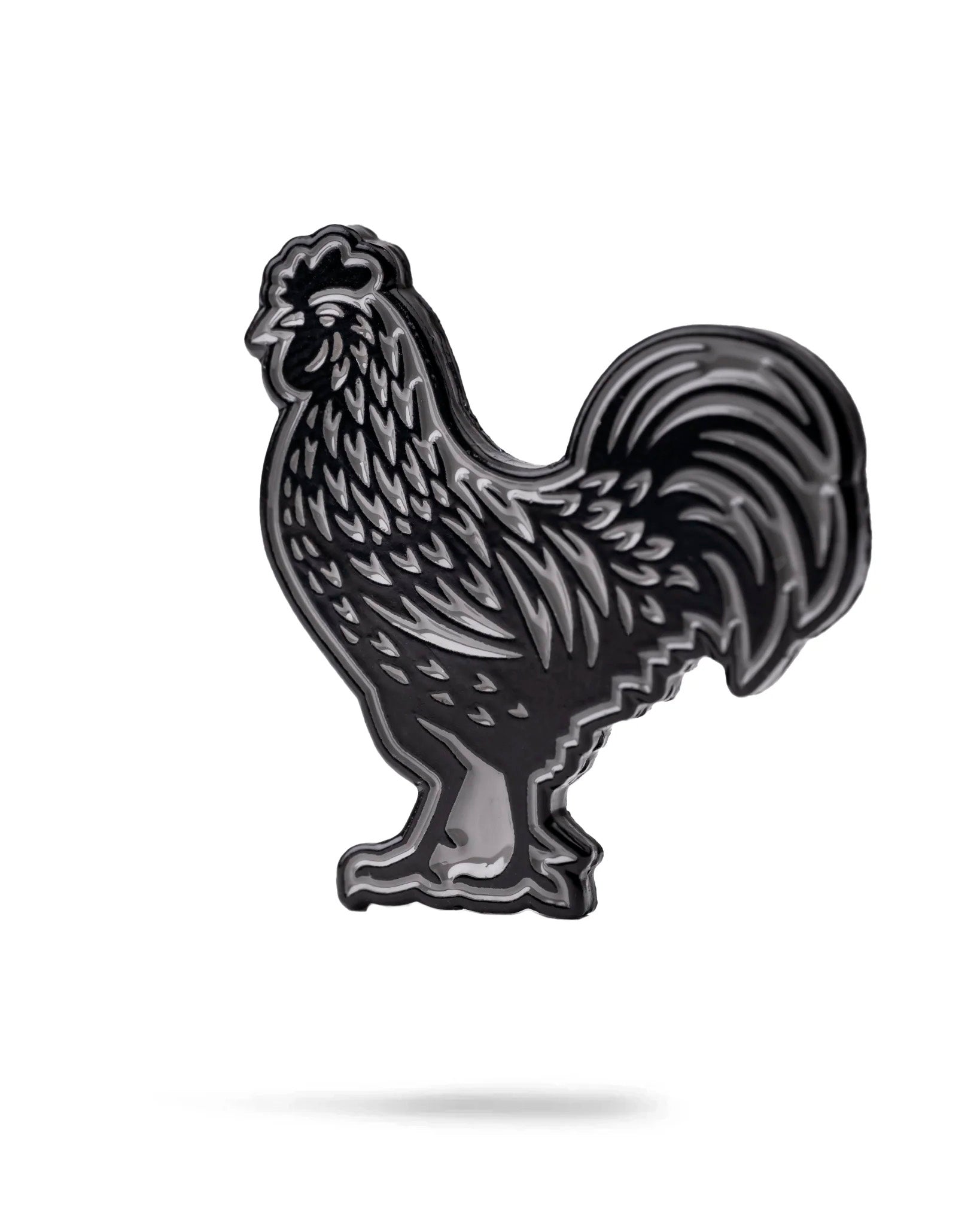 Bold black cock ball marker featuring a detailed rooster design, perfect for golfers looking to add personality to their game.
