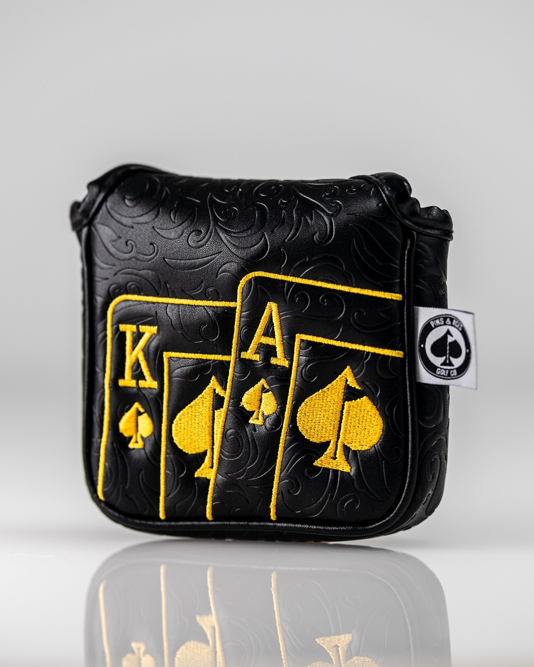 Black and gold mallet putter cover featuring an Ace of Spades design with embossed detailing for a bold golf look.