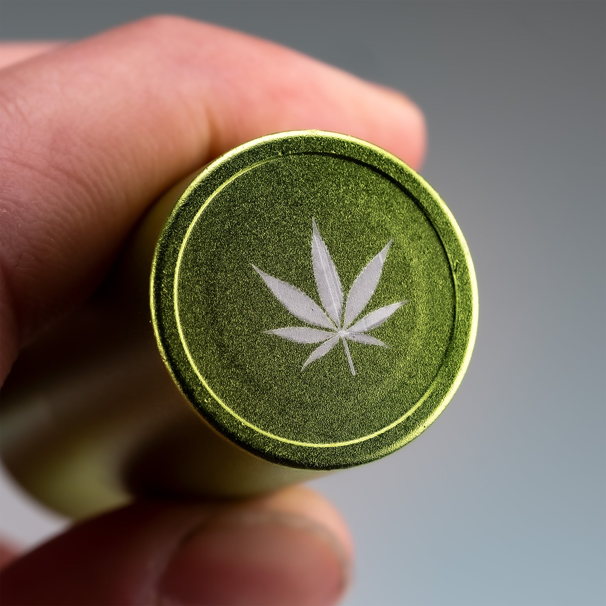 Pot Leaf Ball Stamp featuring a detailed cannabis leaf design on a metallic green base, ideal for personalizing golf balls.