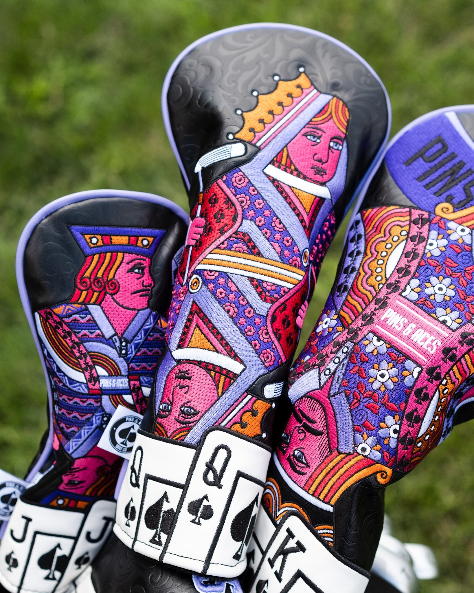 Vibrant Queen of Spades fairway cover featuring intricate designs of playing card characters in bold colors.