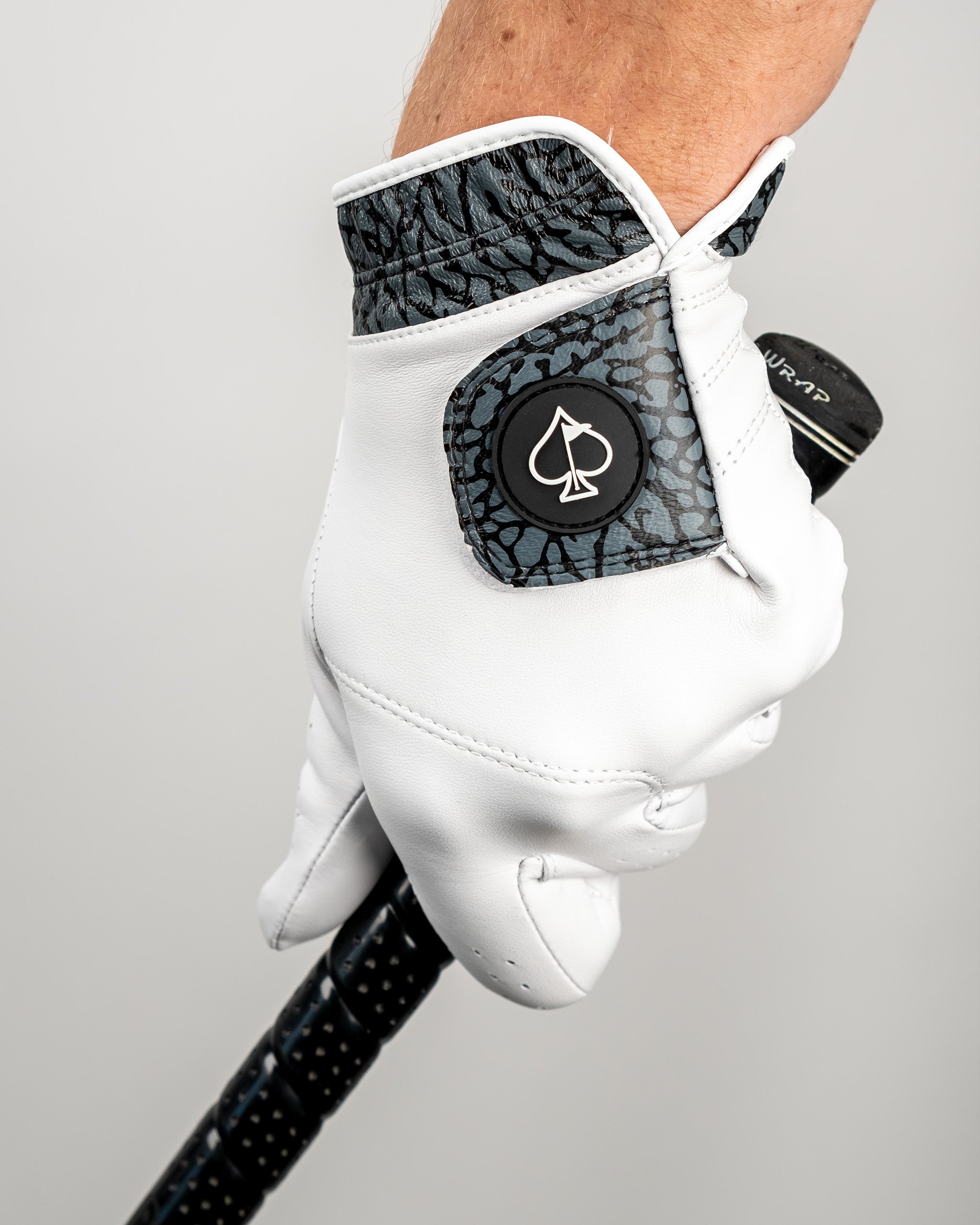 Premium golf glove featuring a stylish elephant print cuff, designed for comfort and performance on the course.