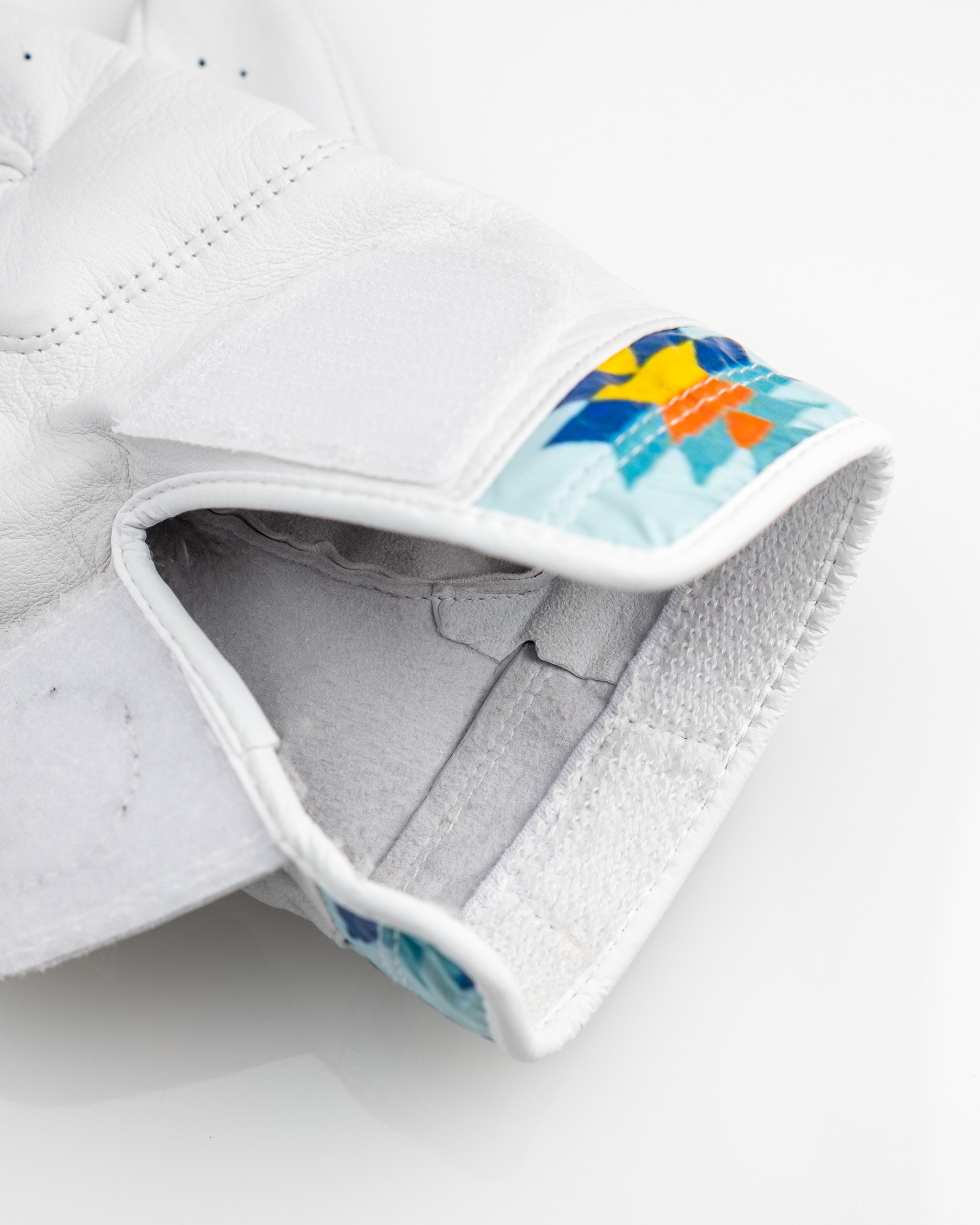 Premium Tour Glove in Southwest Sunset design featuring vibrant colors and a stylish floral pattern on the cuff.