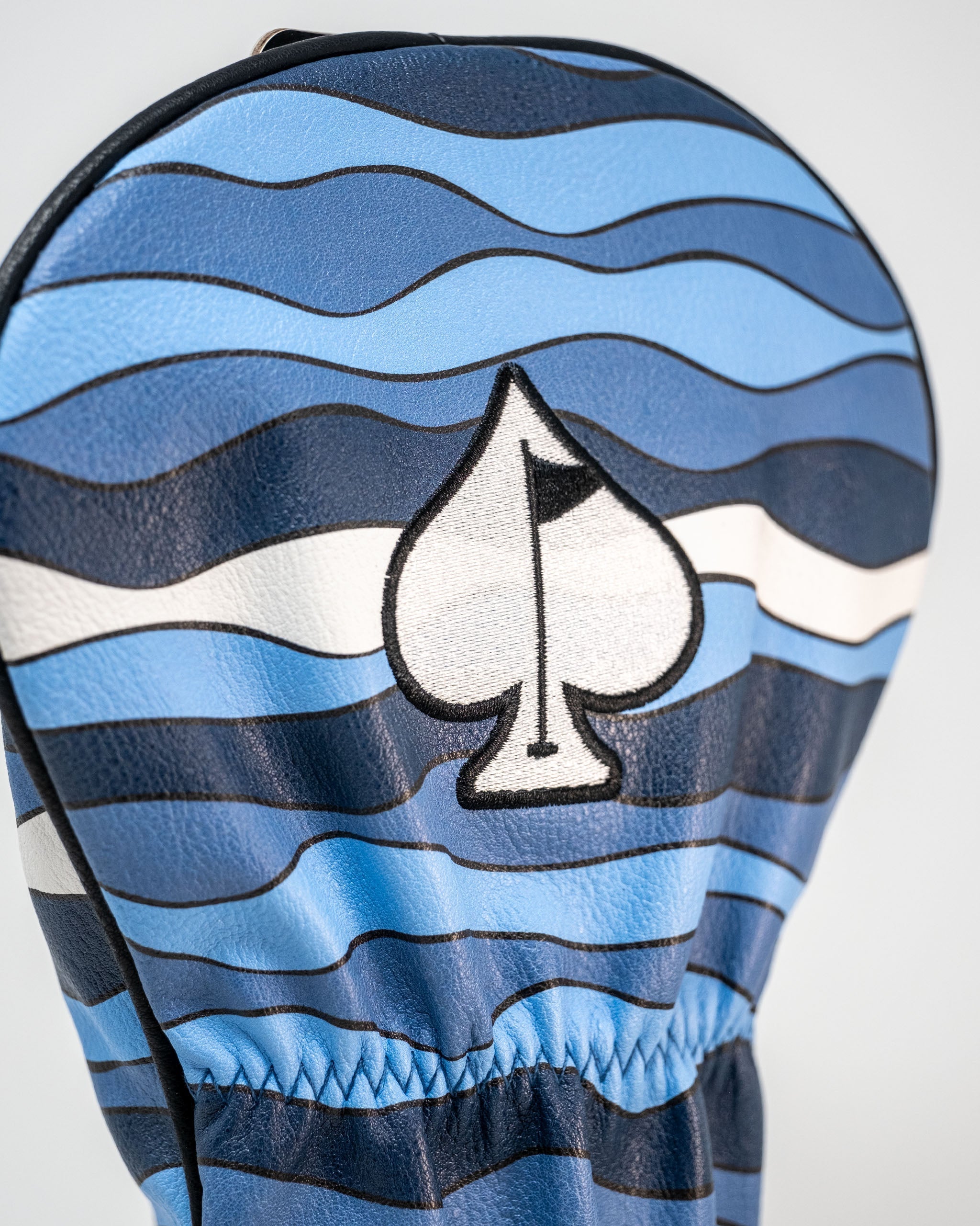 Bold Shark Attack driver cover featuring blue wave patterns and a spade logo, perfect for golfers wanting to stand out.