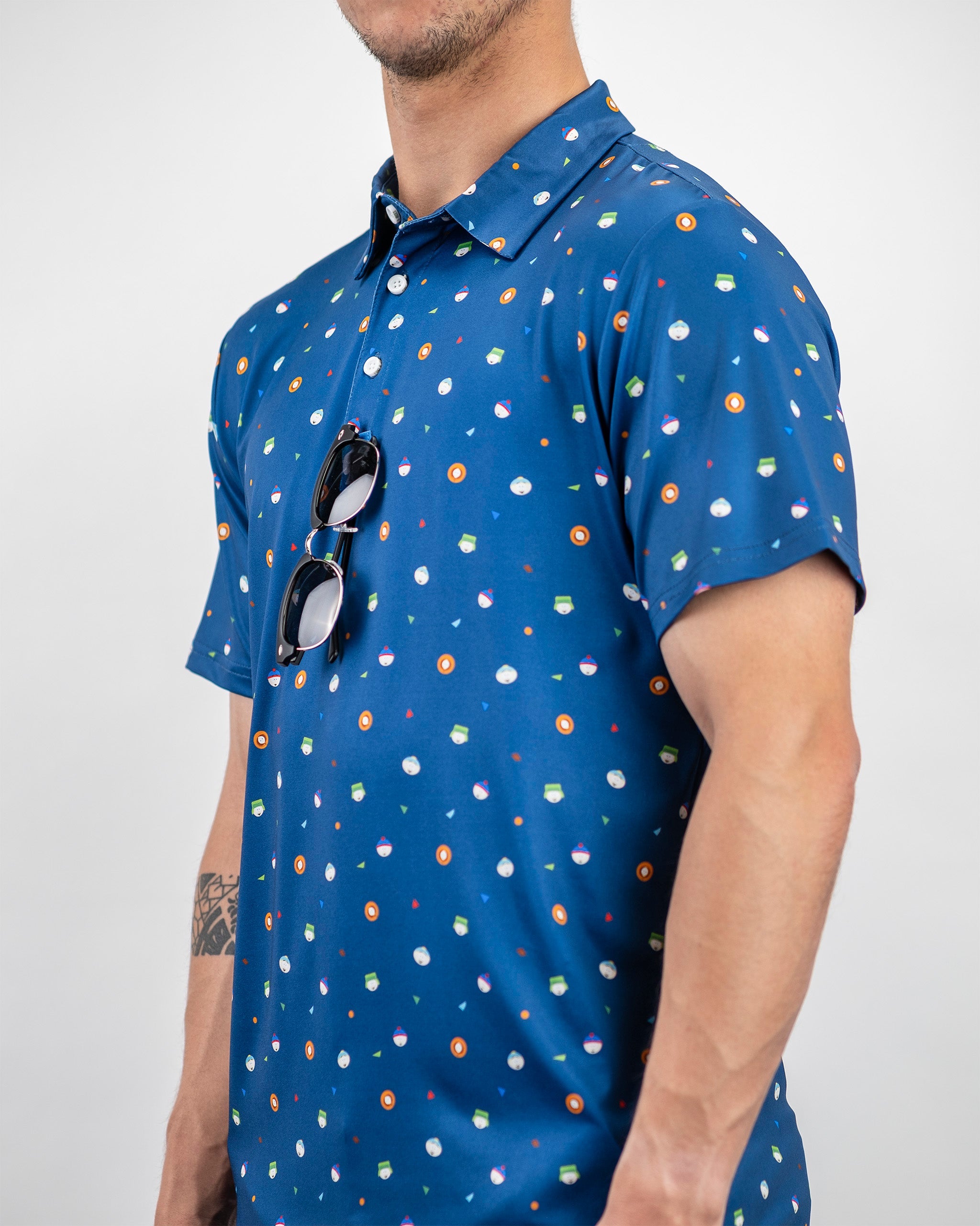 Men's South Park classic polo shirt featuring a blue background with colorful character icons, perfect for bold golf style.