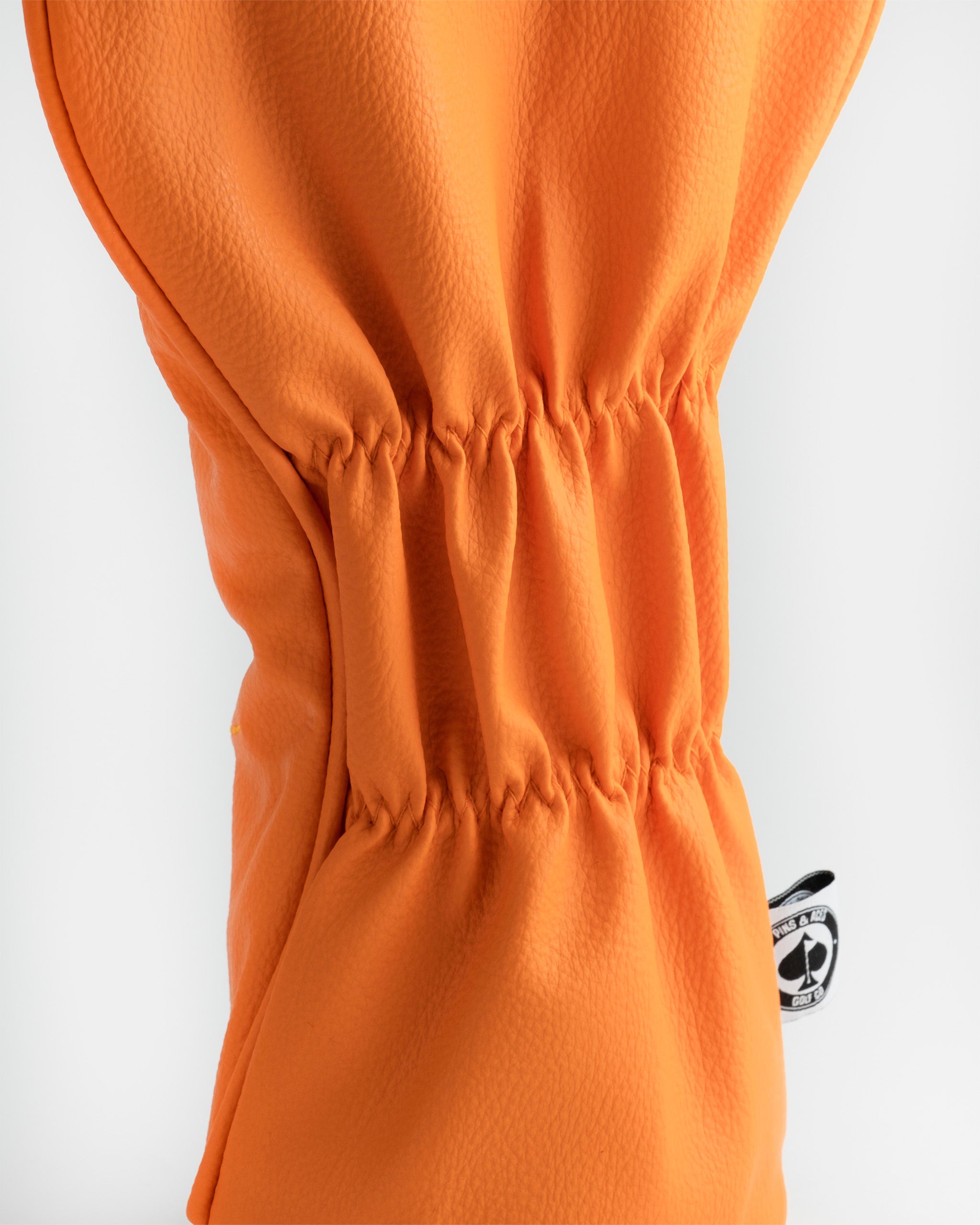 Kenny driver cover in bright orange with a gathered design, perfect for adding a fun touch to your golf gear.