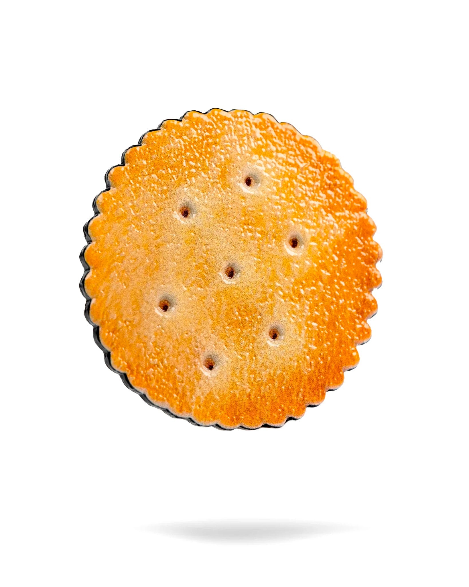 Realistic cracker-shaped ball marker featuring a textured surface and detailed color, perfect for adding fun to your golf game.