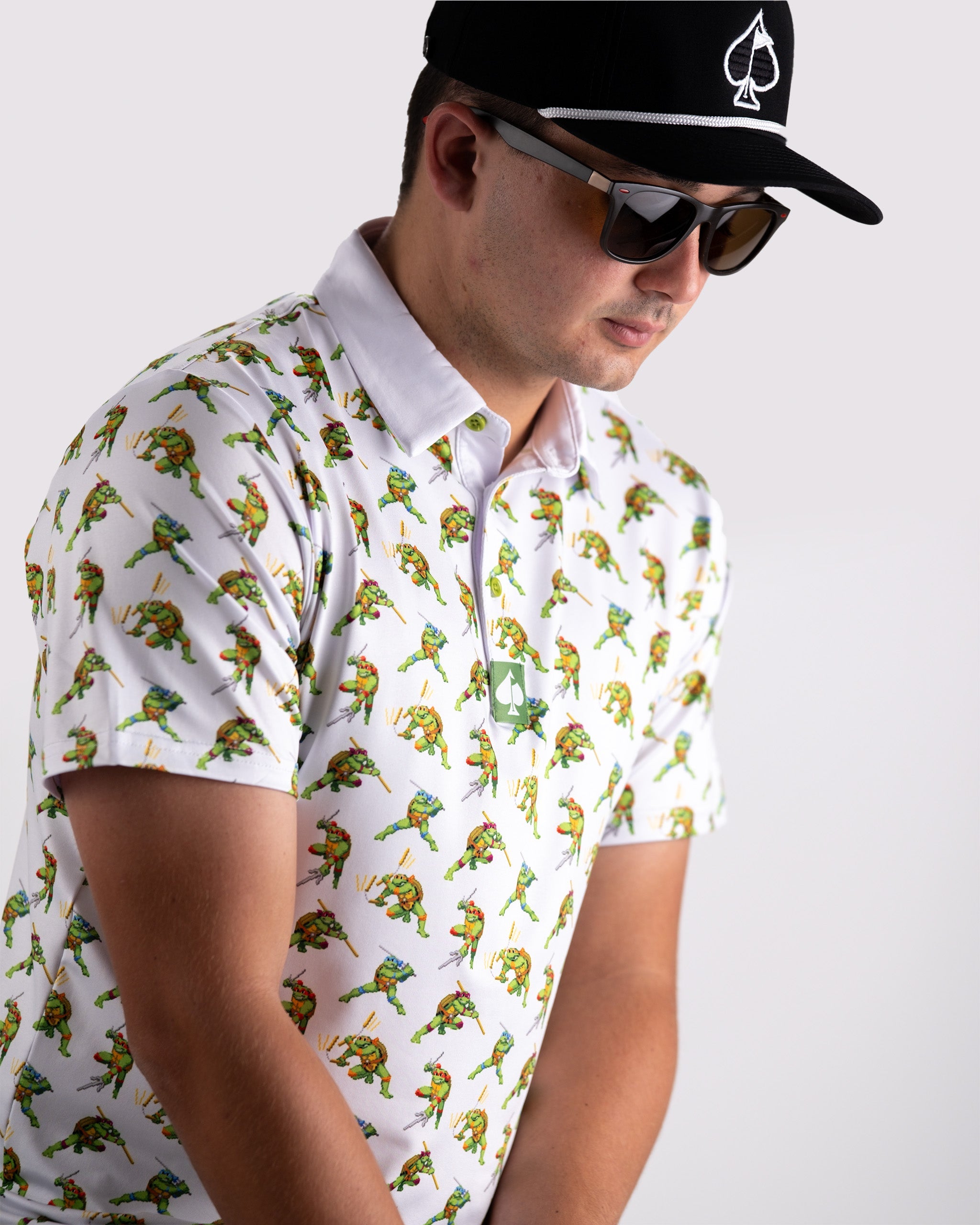 Men's polo shirt featuring a vibrant 8-bit Teenage Mutant Ninja Turtles design, perfect for bold golf style.
