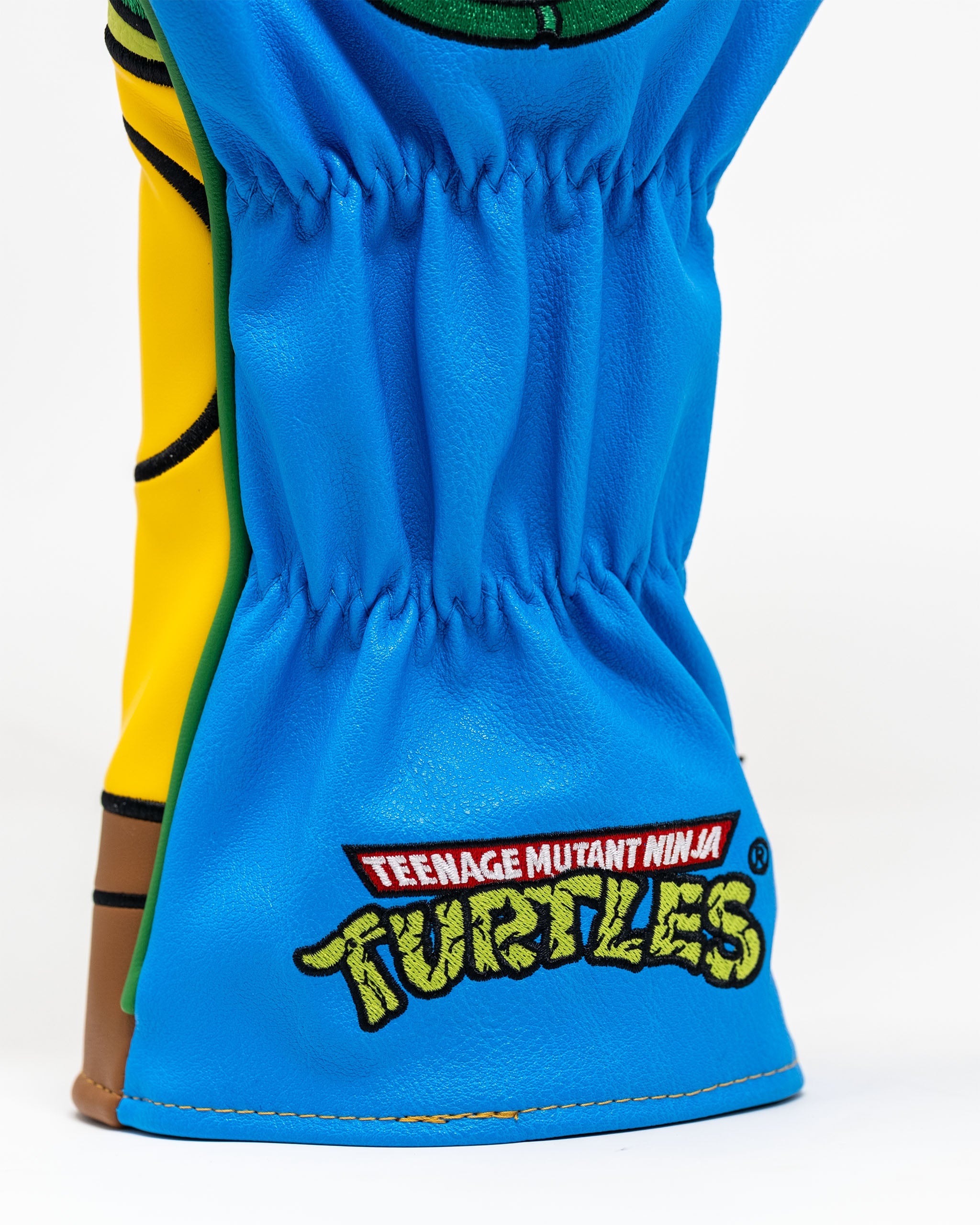 Leonardo driver cover featuring vibrant blue and yellow design with Teenage Mutant Ninja Turtles logo for golf enthusiasts.