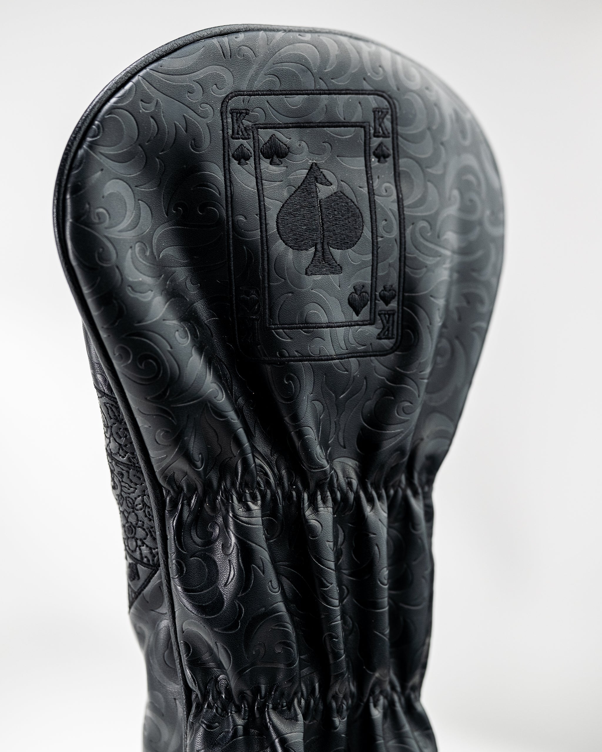 Blackout King of Spades driver cover featuring an embossed playing card design and a sleek black finish.