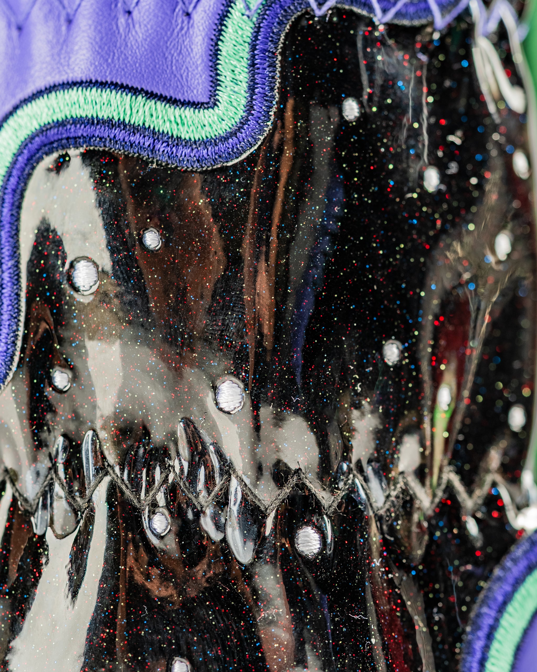 High Orbit hybrid cover featuring a glossy black finish with colorful sparkles and unique stitching details.