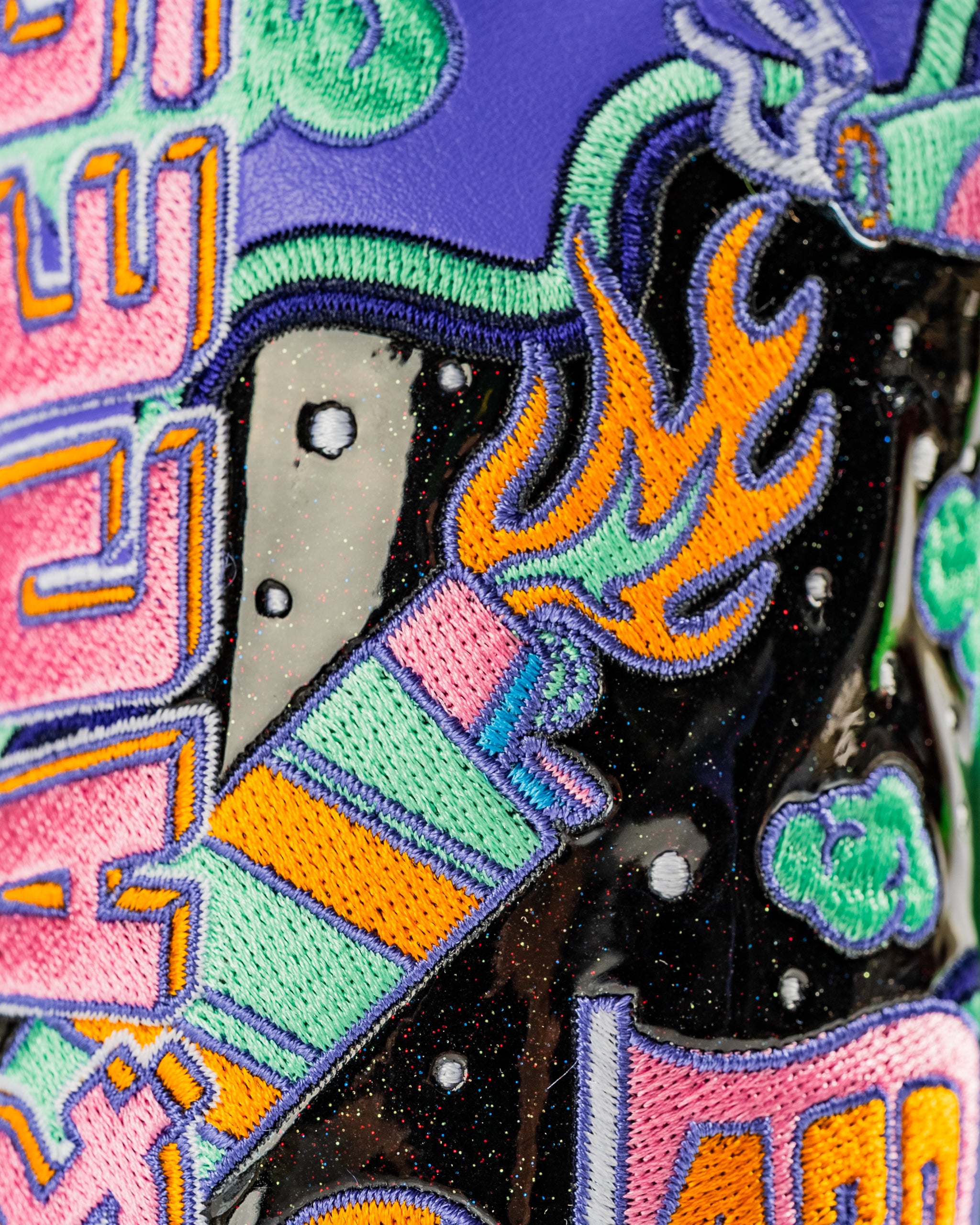 Colorful hybrid golf cover featuring bold embroidery of a rocket, flames, and whimsical clouds for a standout look.