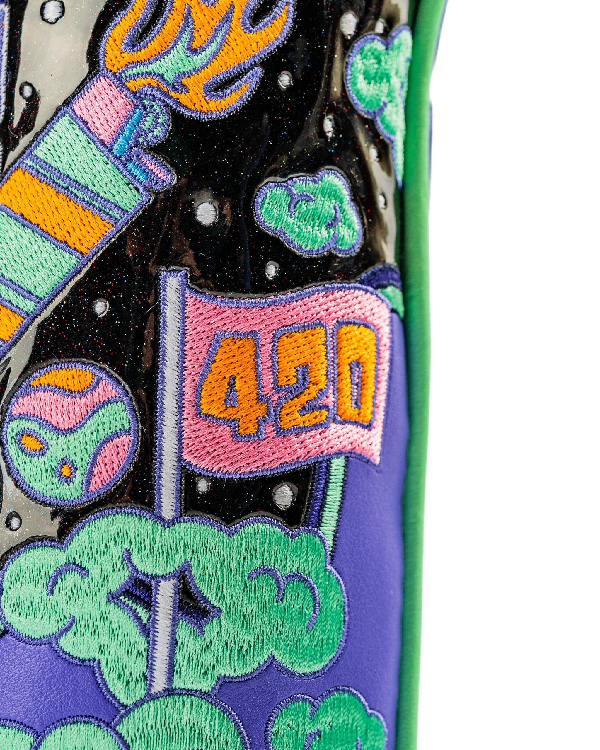 Bold hybrid golf cover featuring vibrant space-themed embroidery, including a flag and colorful clouds. Perfect for standout style.