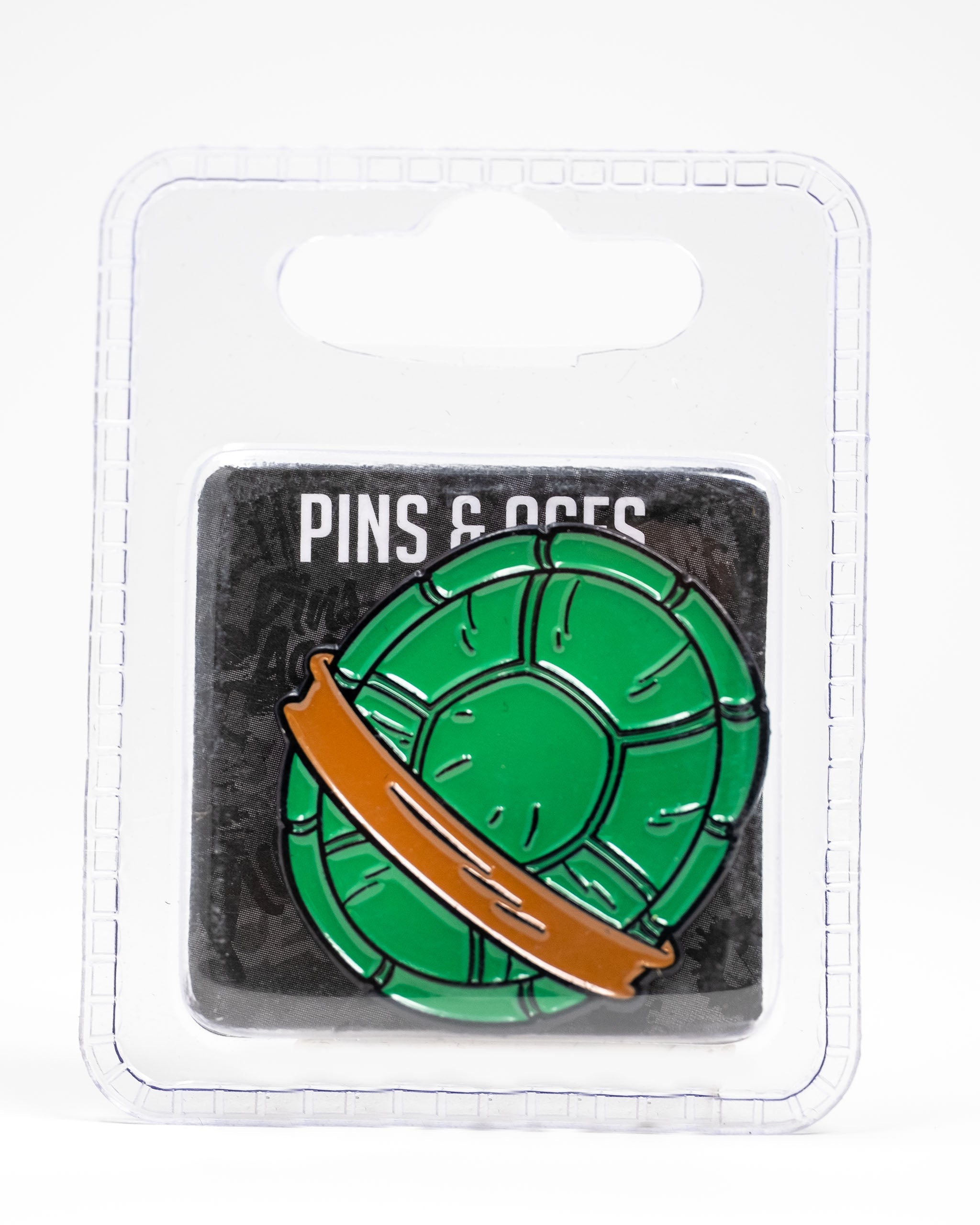 TMNT Shell Shock ball marker featuring a green turtle shell design with a brown band, packaged for golf enthusiasts.