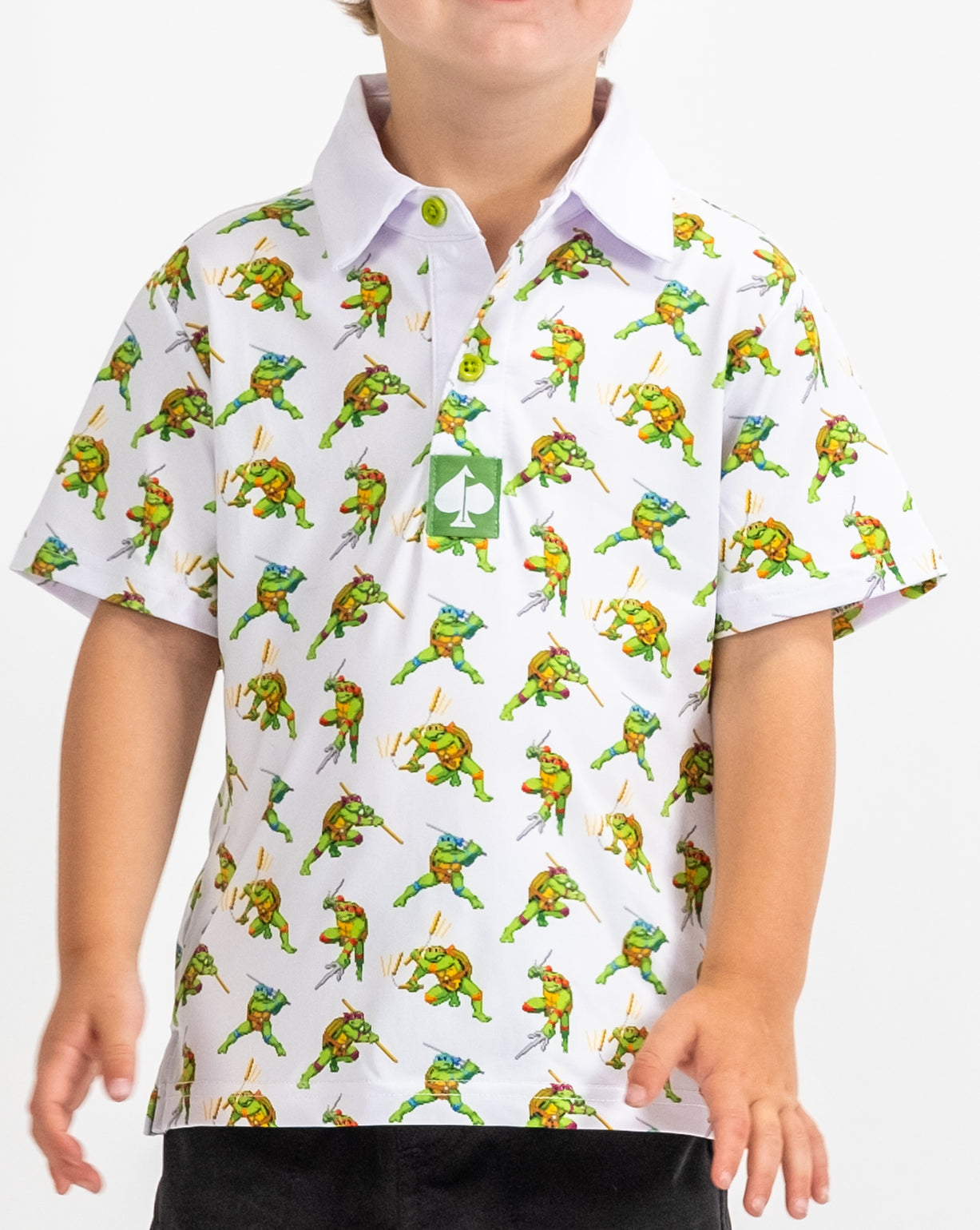 Youth polo shirt featuring an all-over print of Teenage Mutant Ninja Turtles in a vibrant 8-bit style.