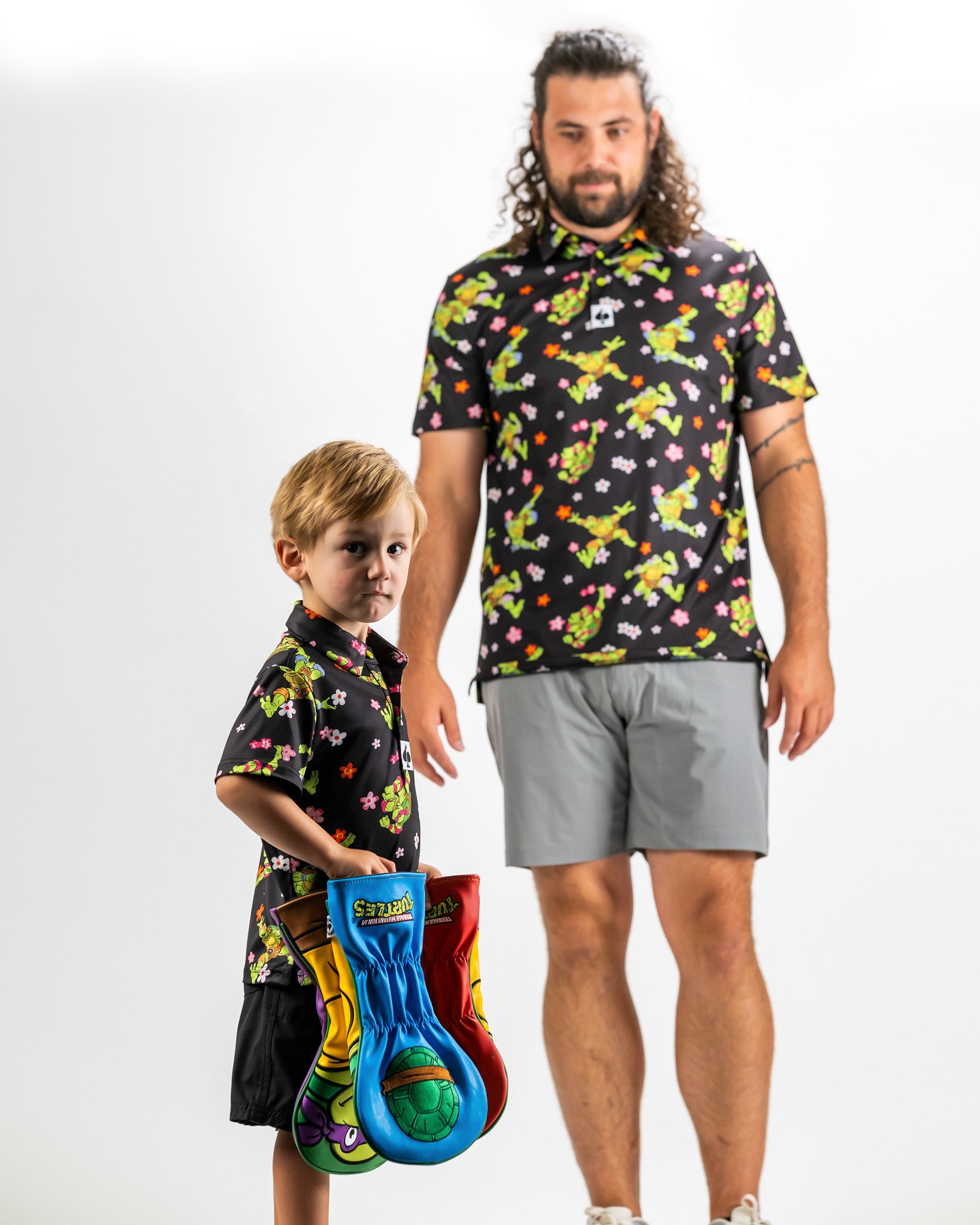 Youth Turtle Flower Power shirt featuring vibrant floral and turtle designs, worn by a child and an adult.
