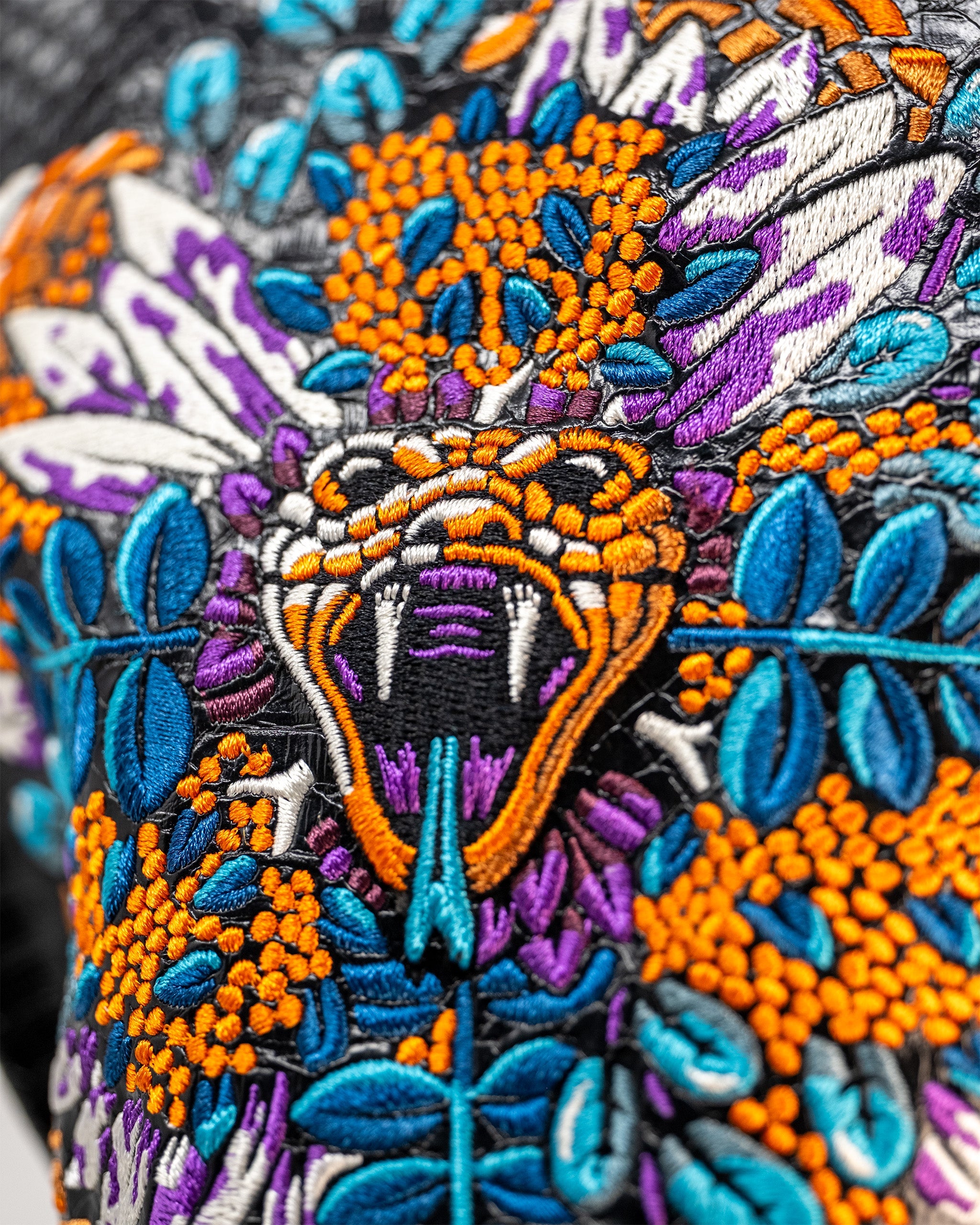 Vibrant Venom Driver Cover featuring intricate snake embroidery with colorful floral accents, perfect for bold golfers.