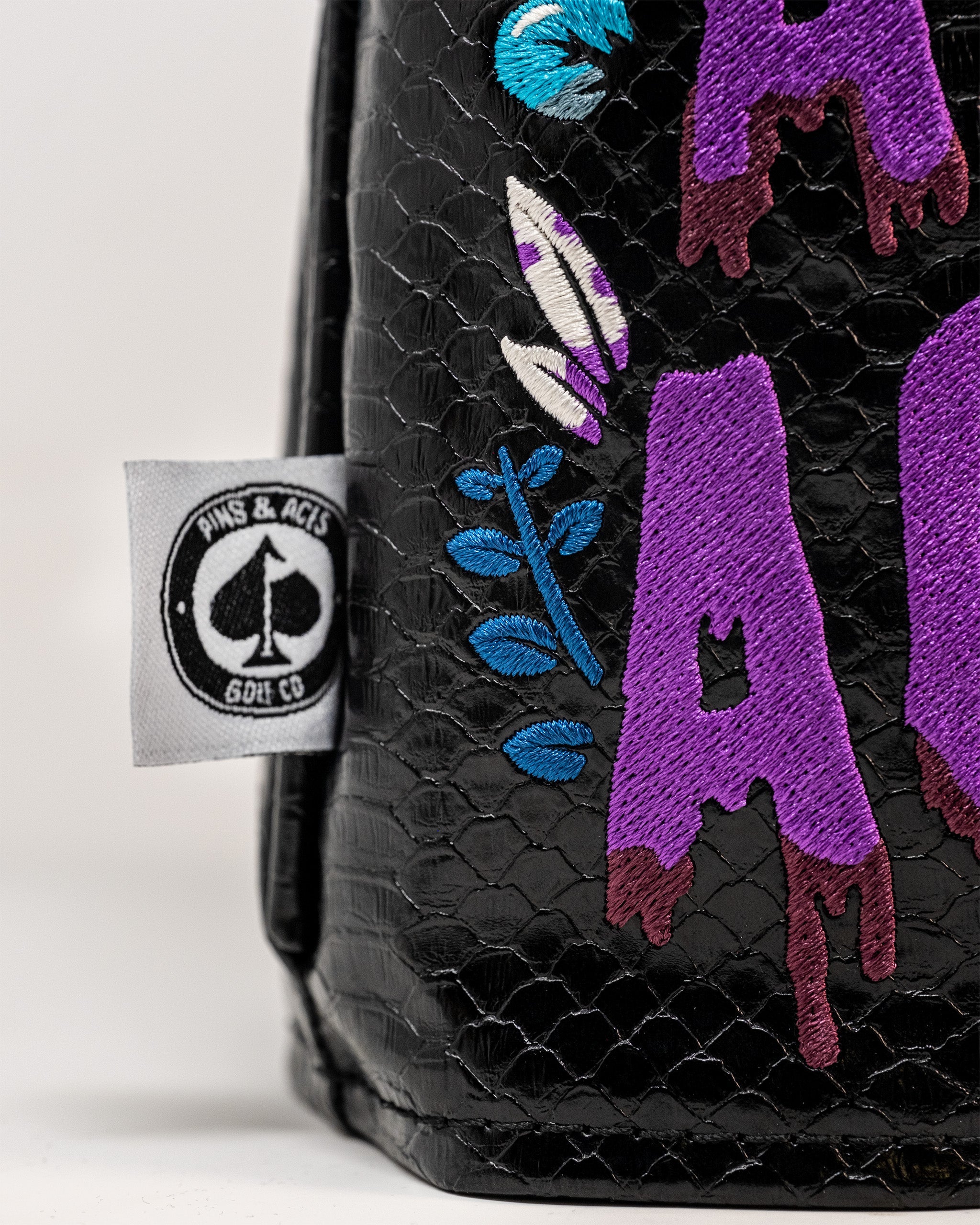 Bold Venom driver cover featuring vibrant purple and teal graphics on a textured black background, perfect for golfers.