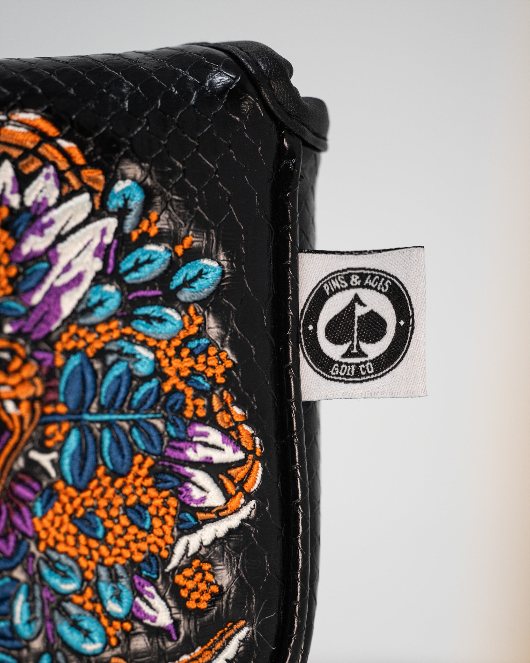 Bold Venom mallet cover featuring intricate floral embroidery and a textured black finish, perfect for stylish golfers.