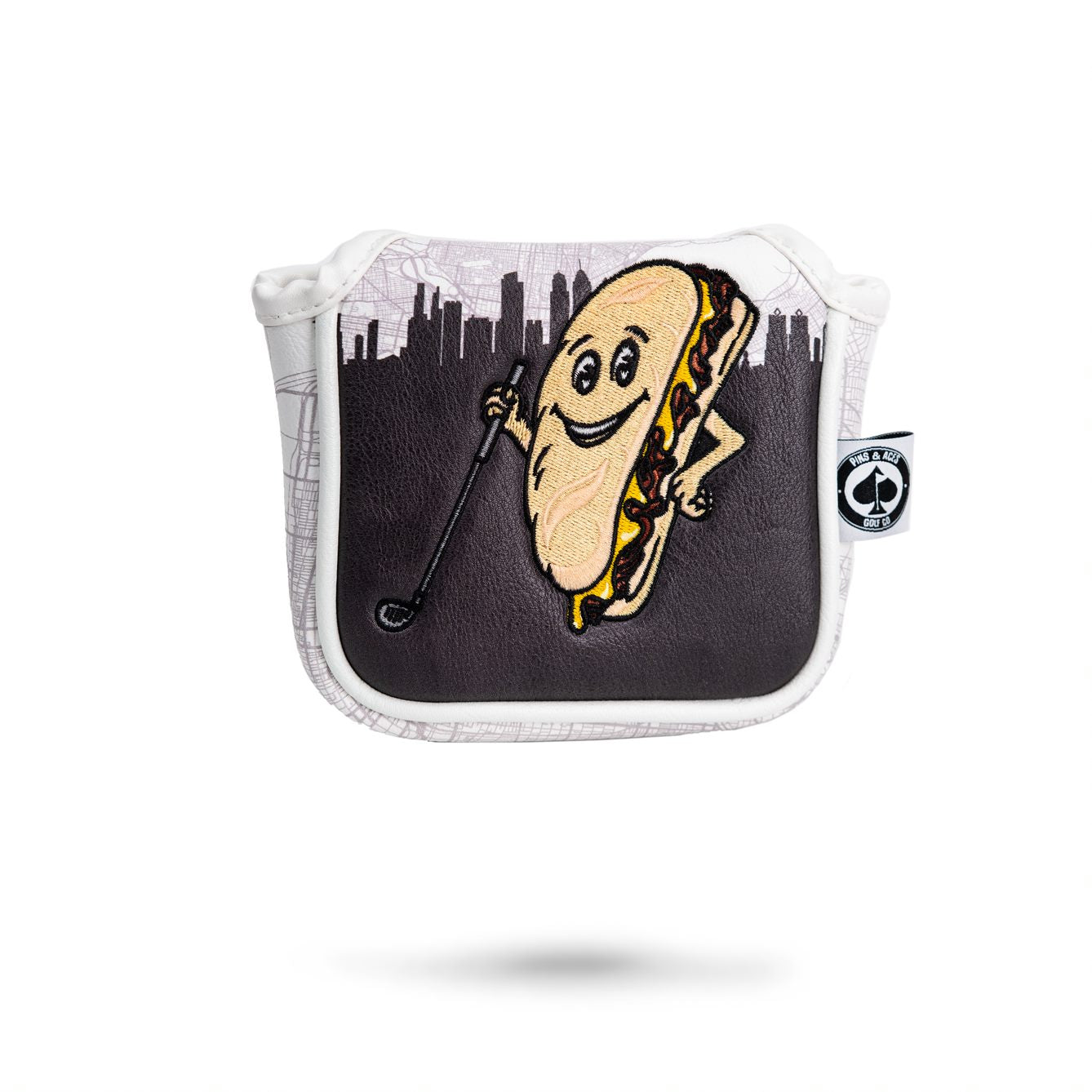 Whiz Wit Mallet Cover featuring a playful hot dog character holding a golf club against a city skyline background.