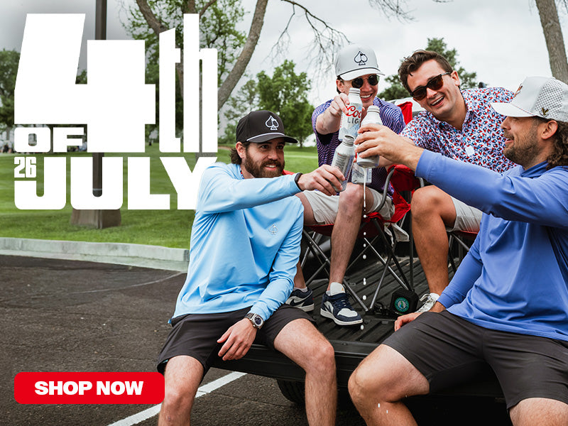 Friends enjoying drinks together in a truck bed, celebrating the 4th of July in stylish golf apparel.